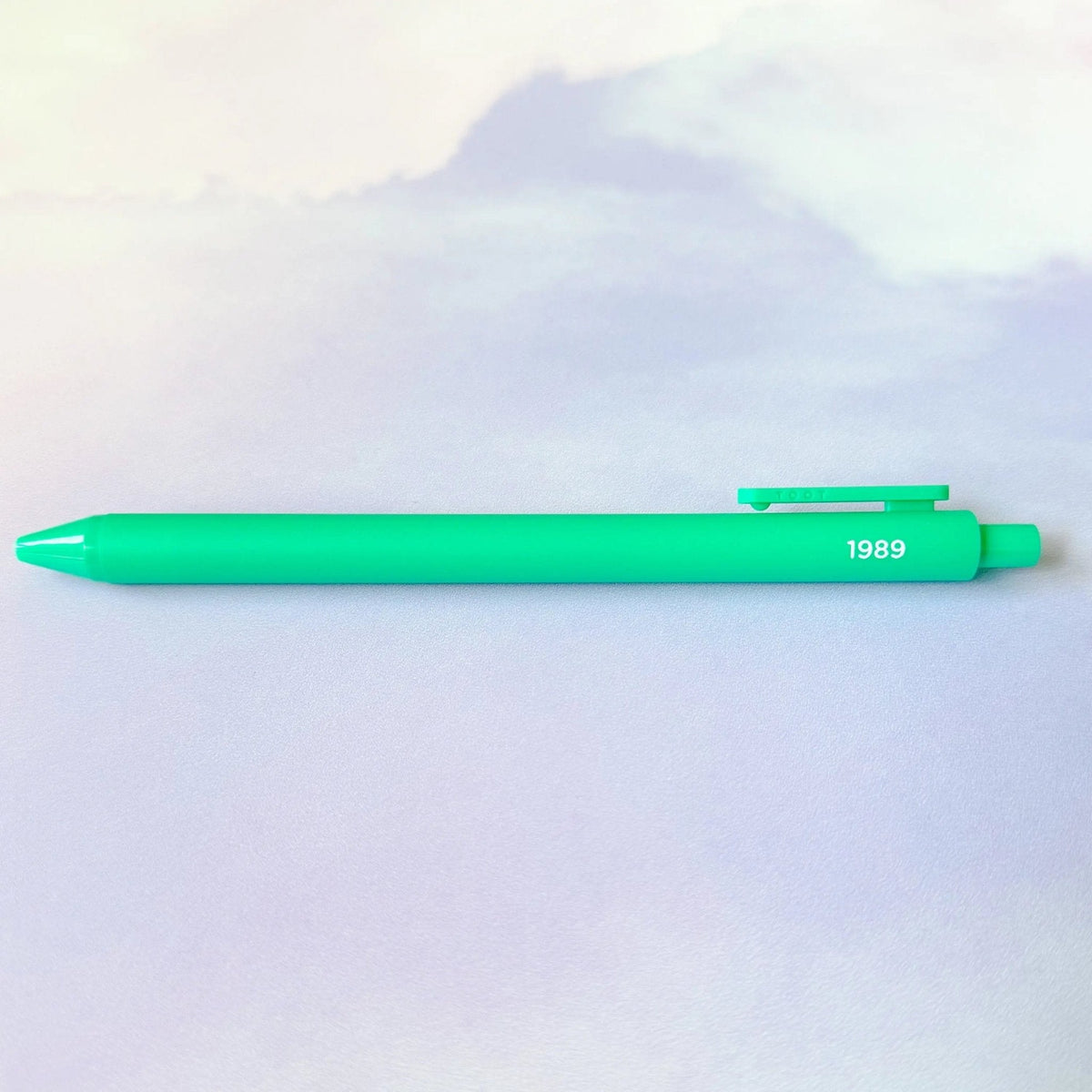 1989 jotter pen detail — embossed year lettering on a teal barrel by indie artist MangoIllustrated