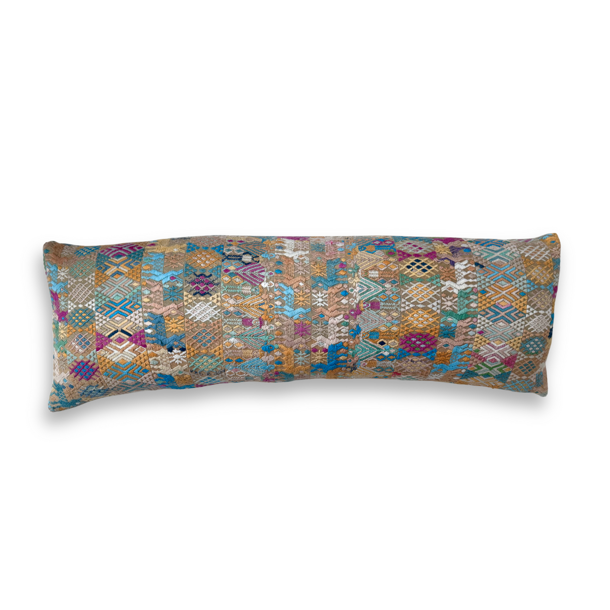 Long, rectangular pillow with a multicolored geometric pattern on a white background