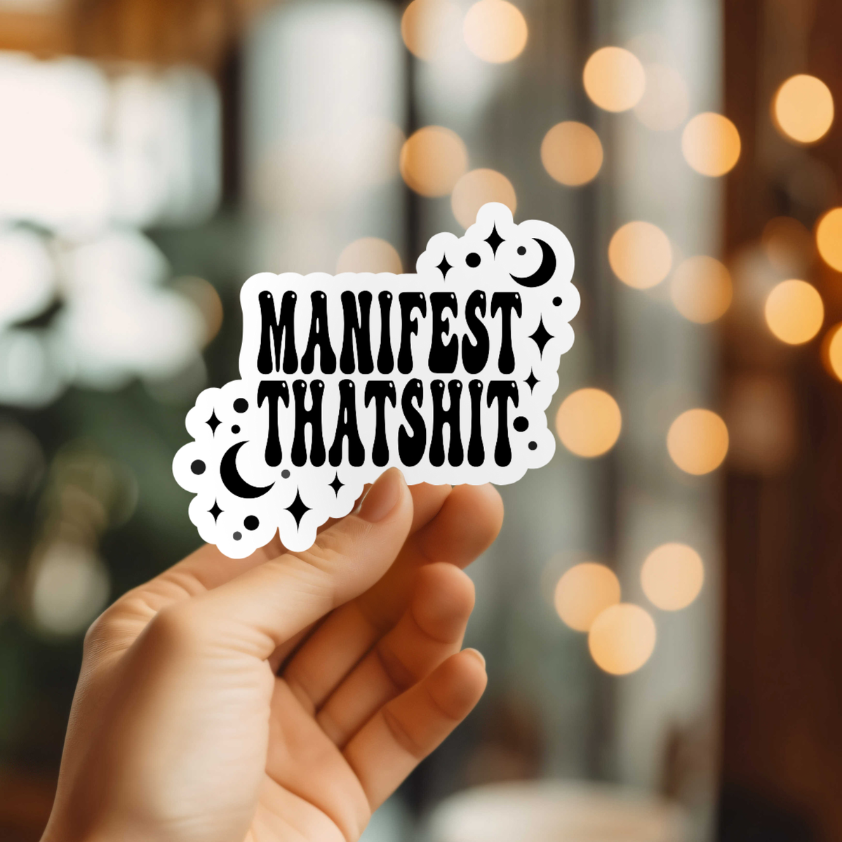 Hand holding a sticker with &