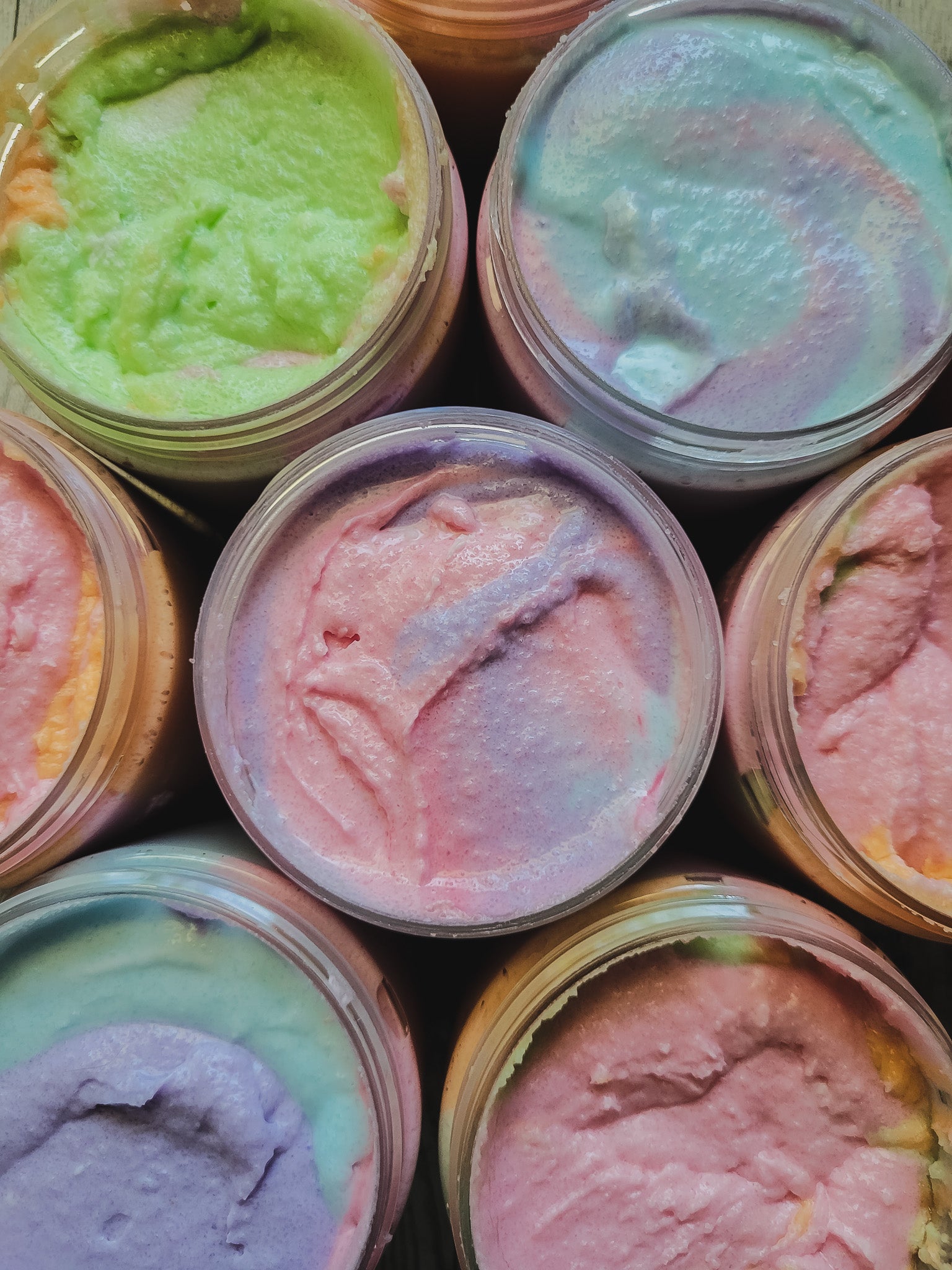 Jars of colorful, creamy substances with a close-up view.