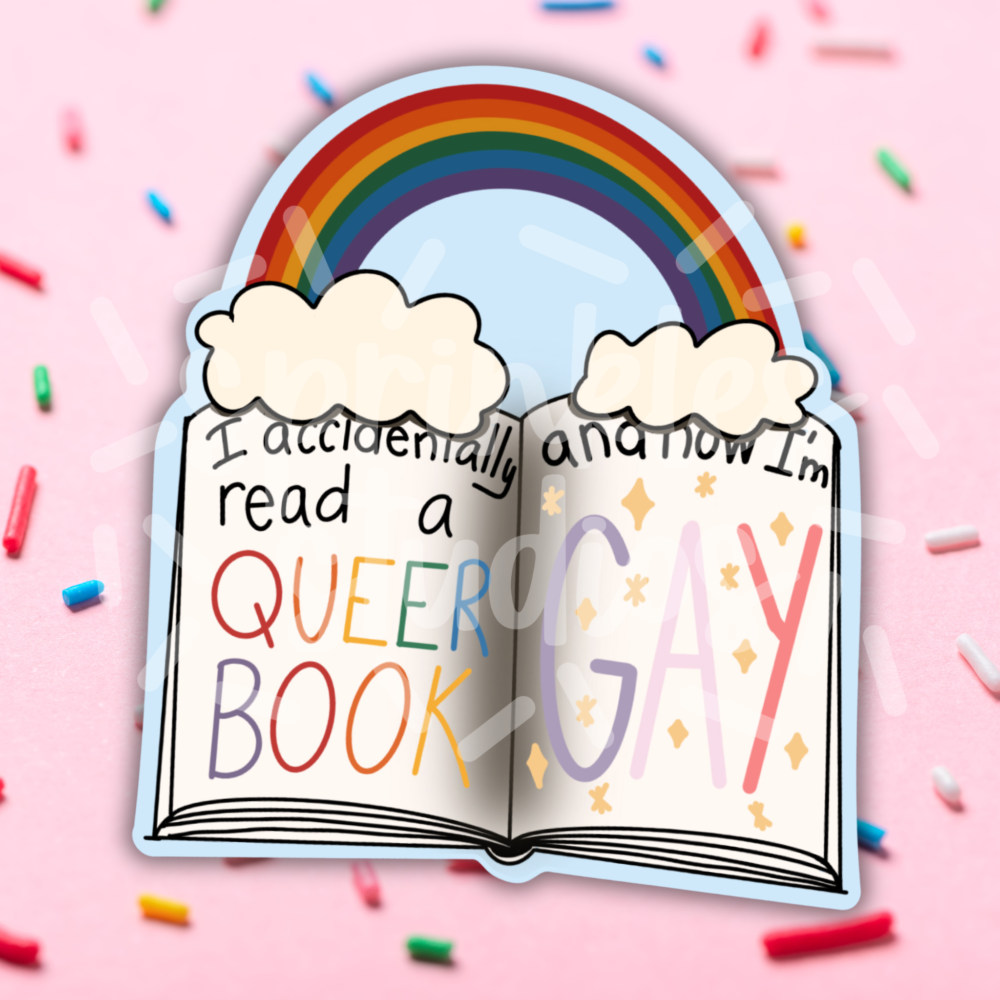 Open book with rainbow text on a pink background with sprinkles