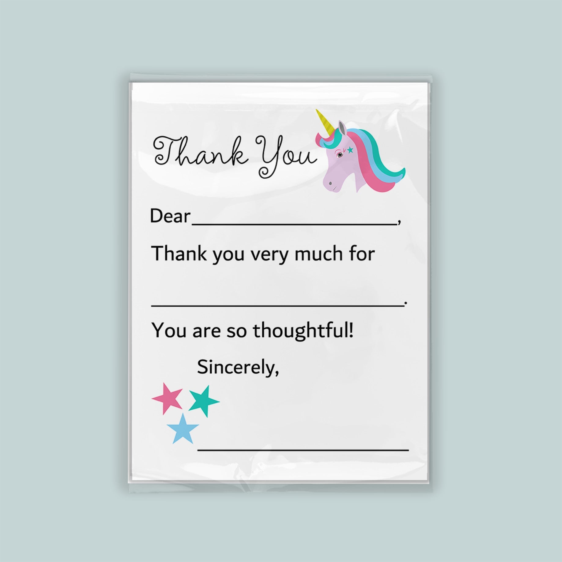The image is a white thank you card with a unicorn illustration and stars. The card has a blank space for a recipient&