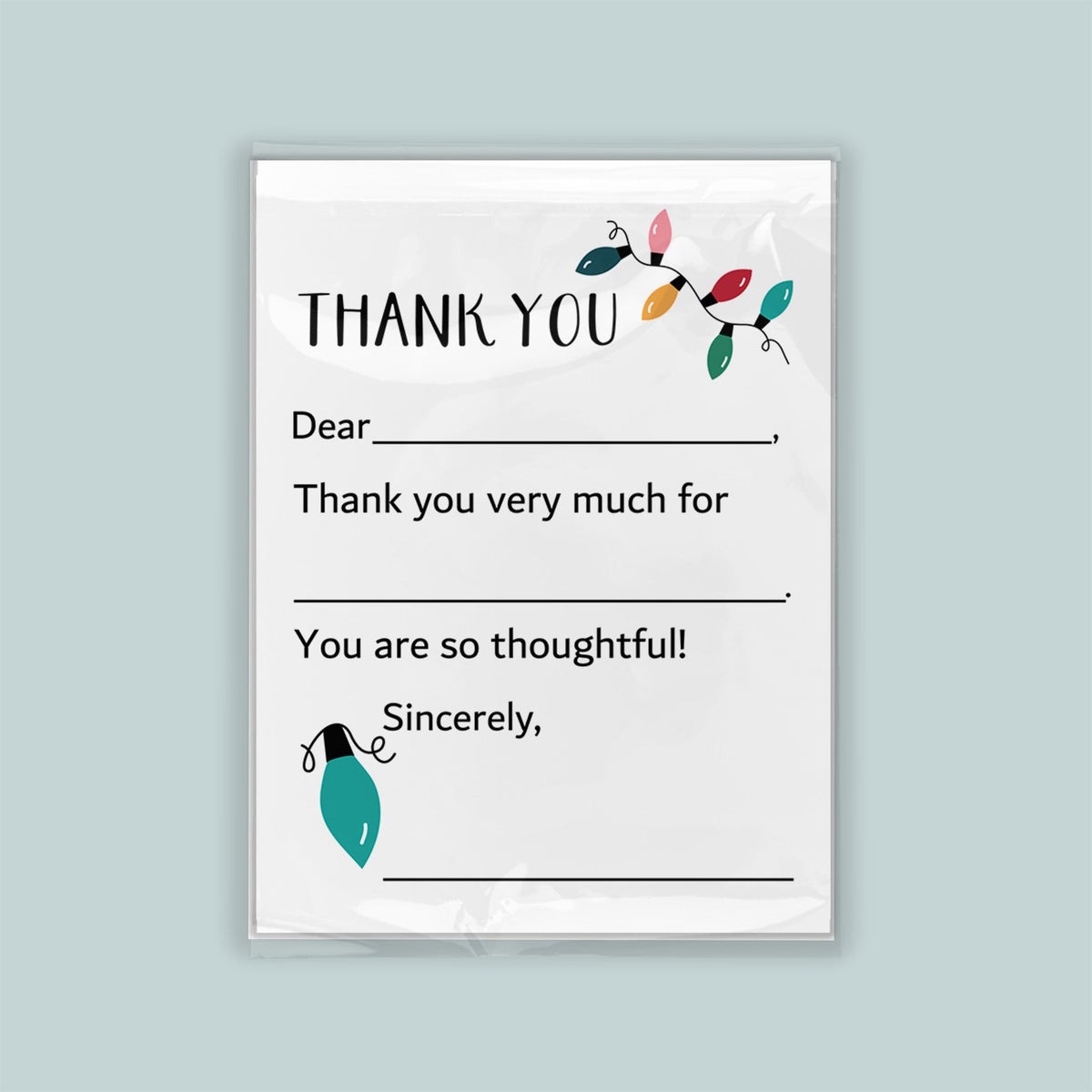 The image is a white thank you card with a green light bulb and colorful lights on the left side. The card has a blank space for a recipient&