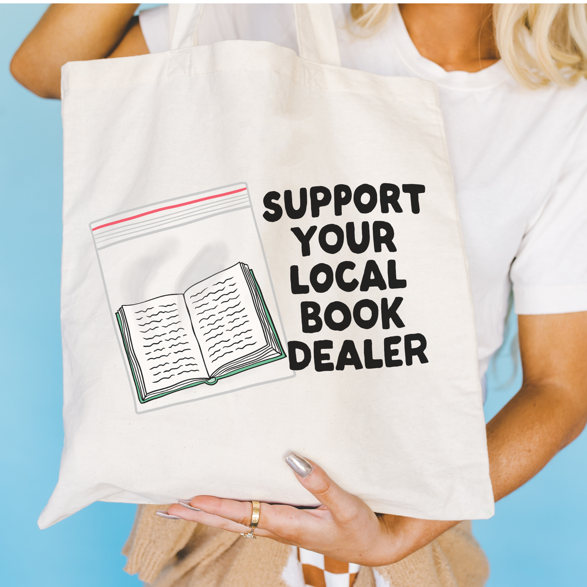 Person holding a tote bag with &