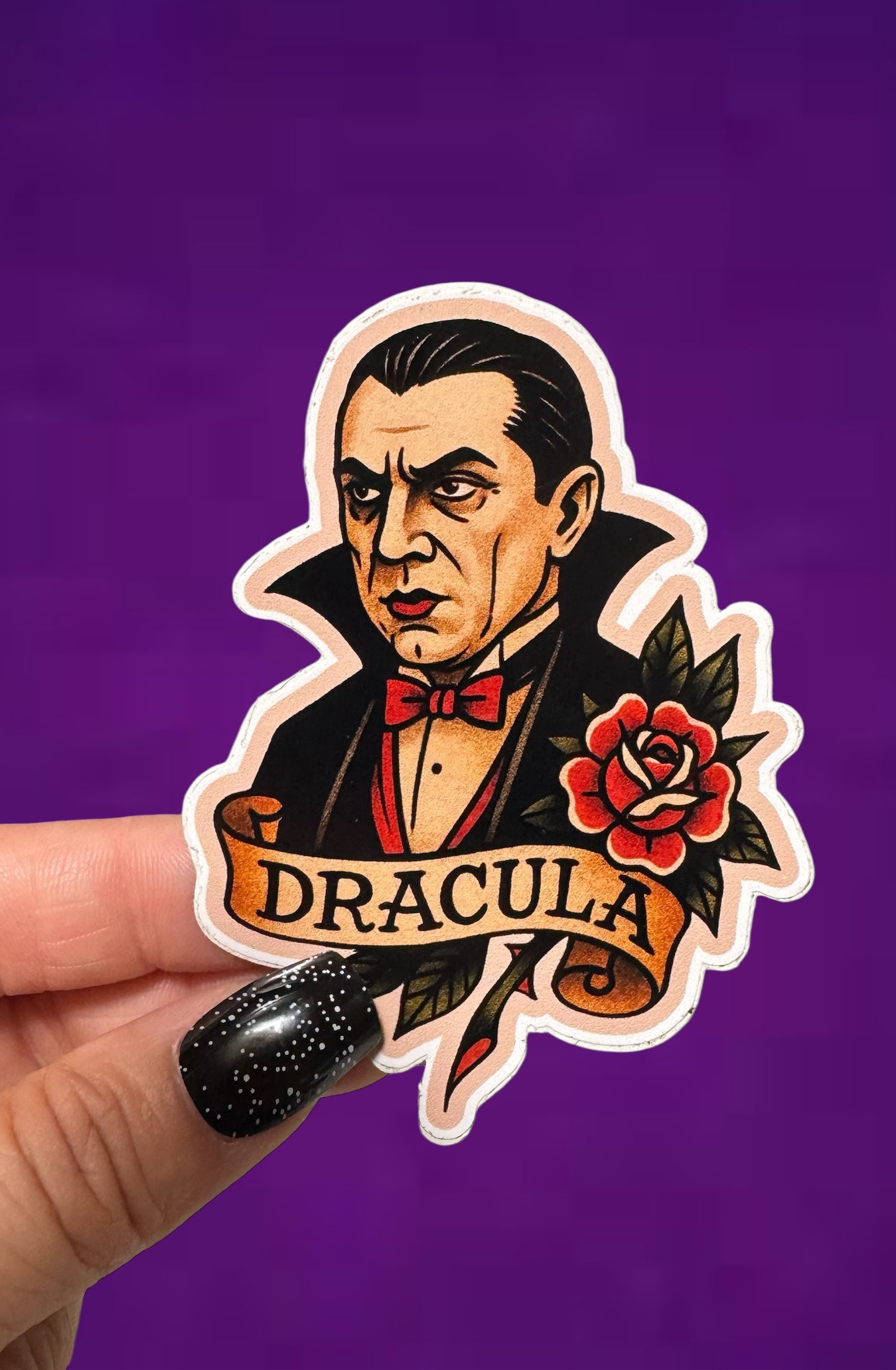 Sticker of a character inspired by Dracula held against a purple background