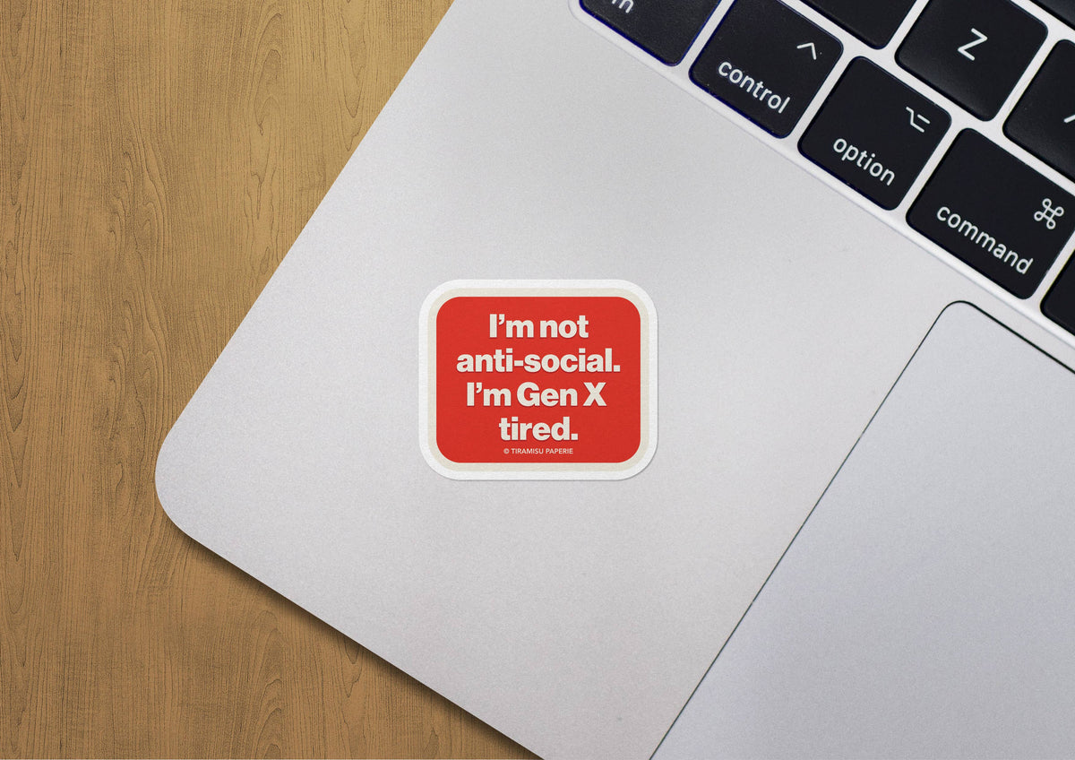 Laptop with a sticker on the palm rest area, featuring text &