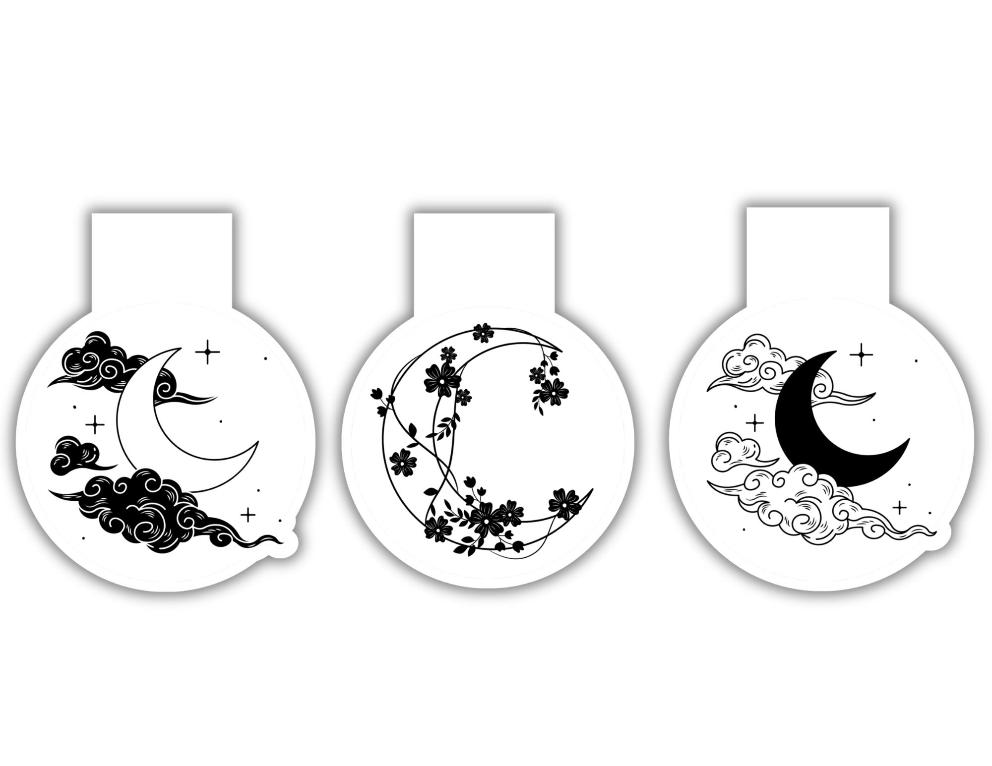 Three decorative items with crescent moon and floral designs on a white background