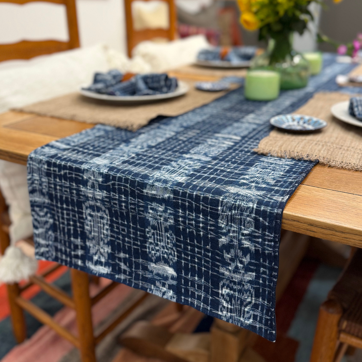 Blue patterned table runner on a wooden table with a blurred background