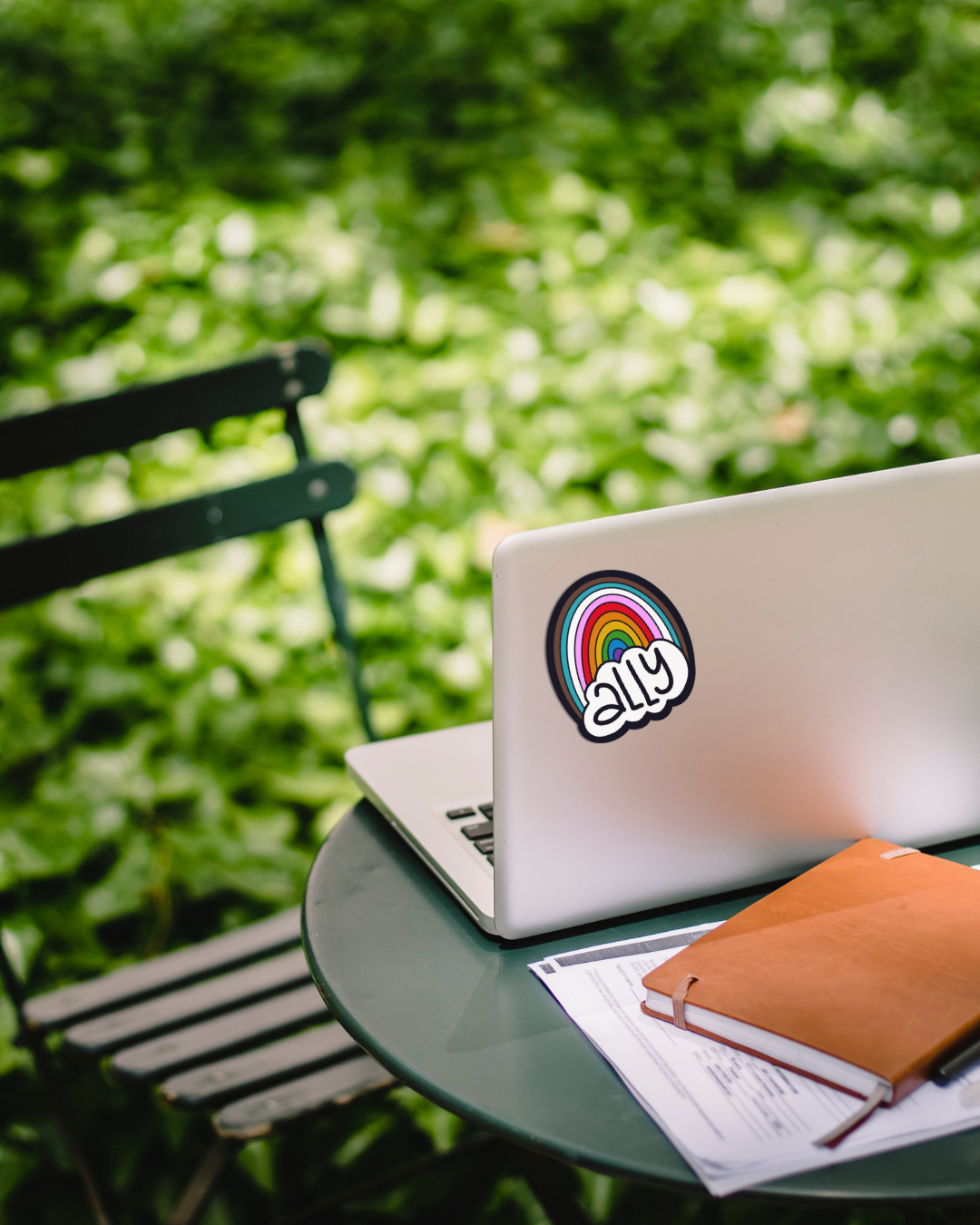 Laptop with a sticker on a table outdoors