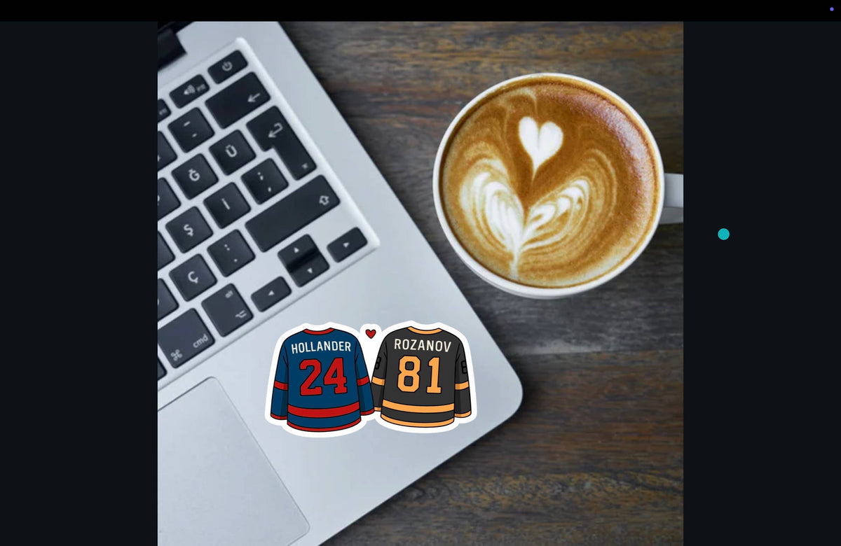 Laptop with hockey jerseys on stickers next to a cup of coffee with latte art.
