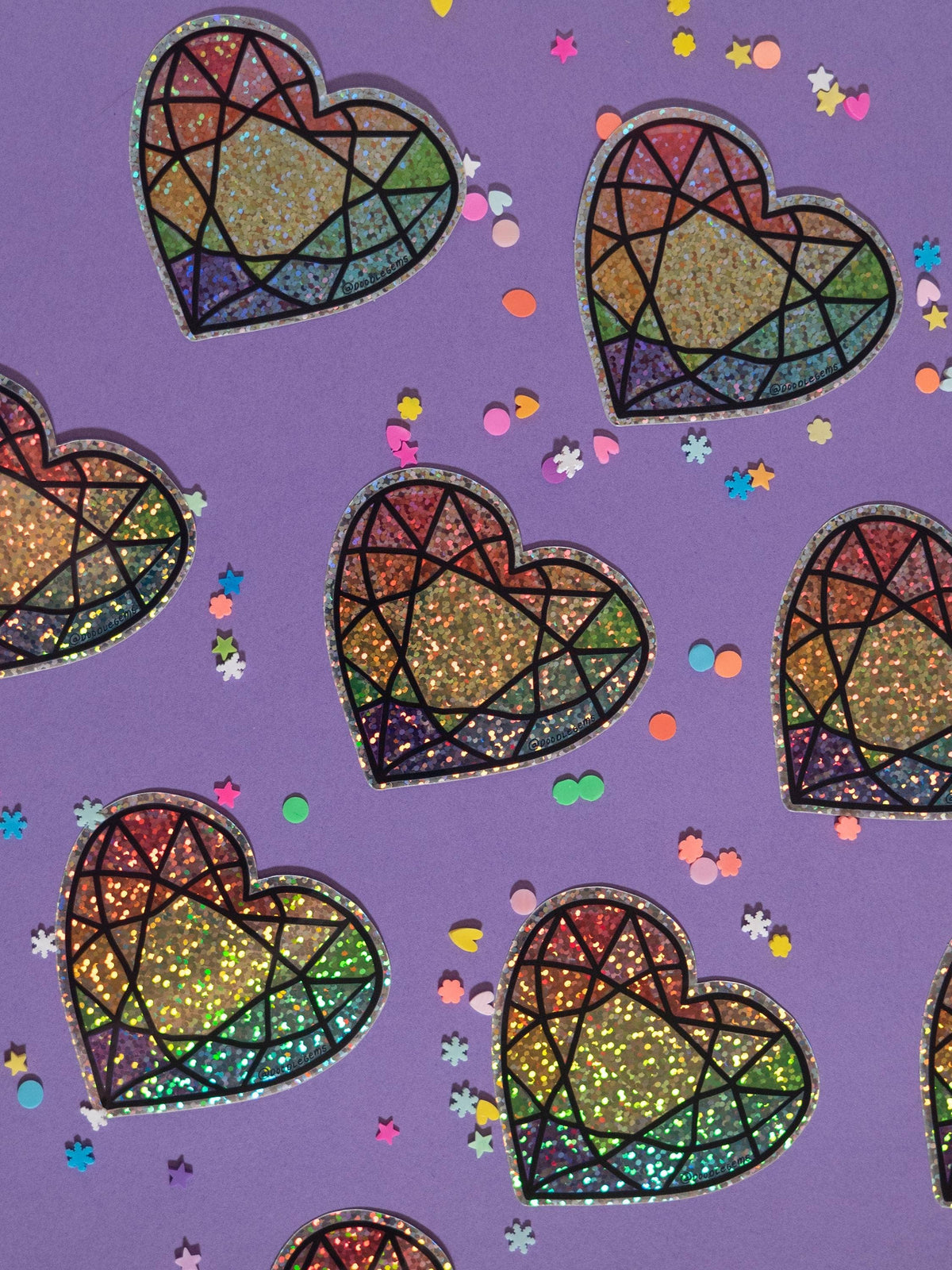 Colorful heart-shaped stained glass patterns on a purple background with confetti.