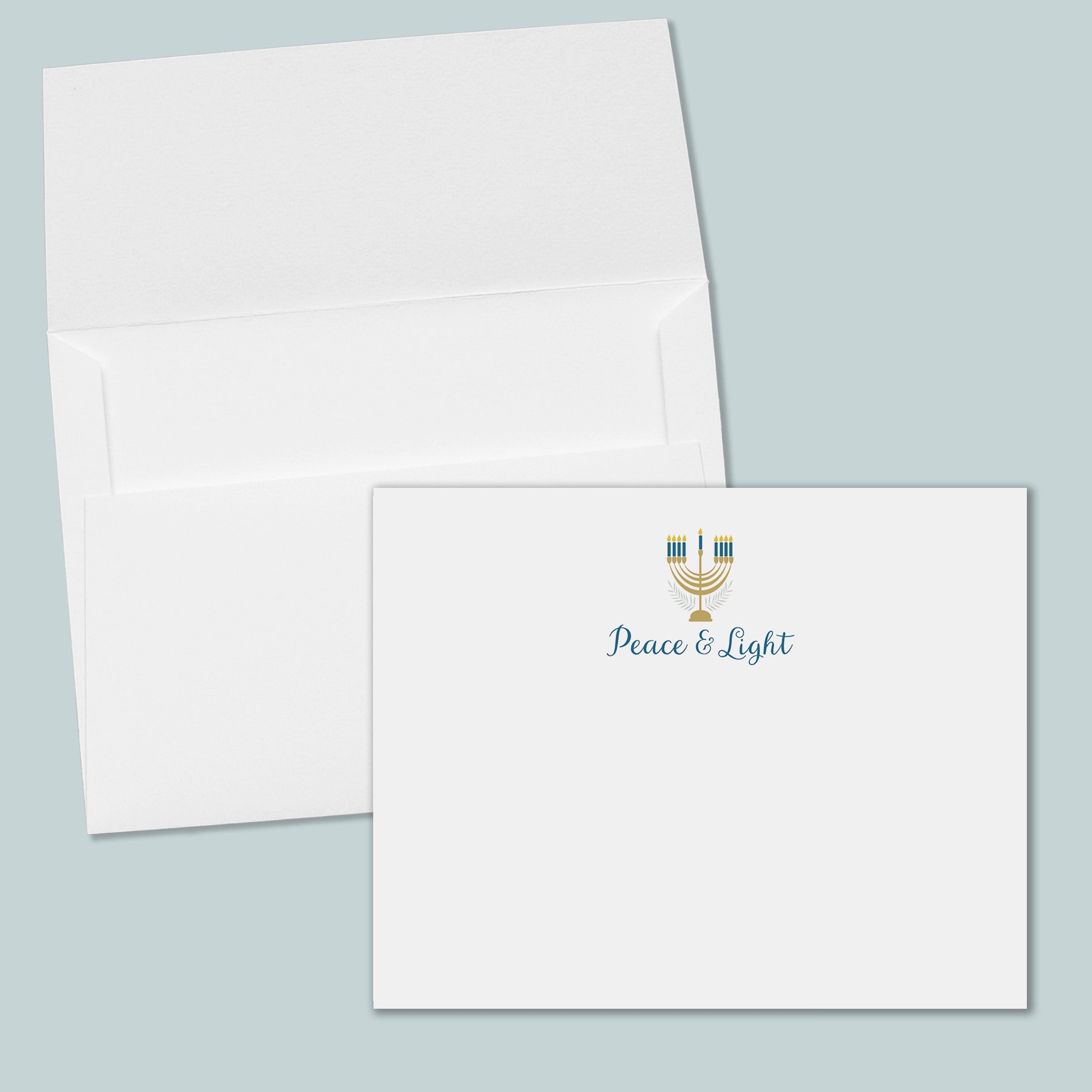 an open white envelope with a printed "Peace & Light" logo on the front.