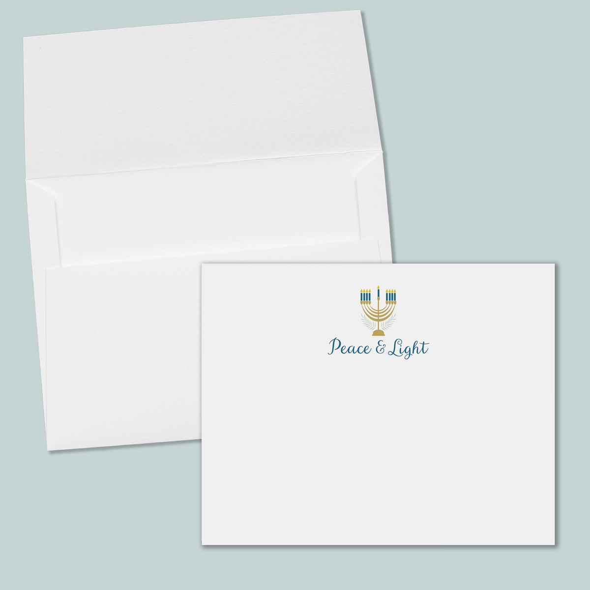 an open white envelope with a printed "Peace & Light" logo on the front.