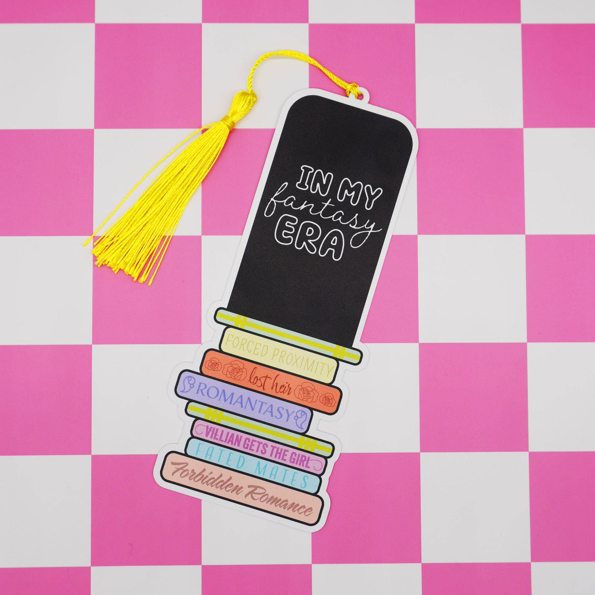 Book-themed bookmark with colorful text on a pink and white checkered background