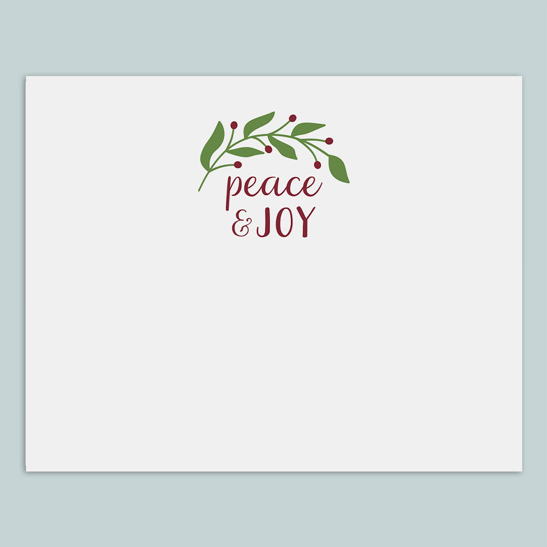 The image is a white card with a decorative wreath and the text "Peace & Joy" written on it.