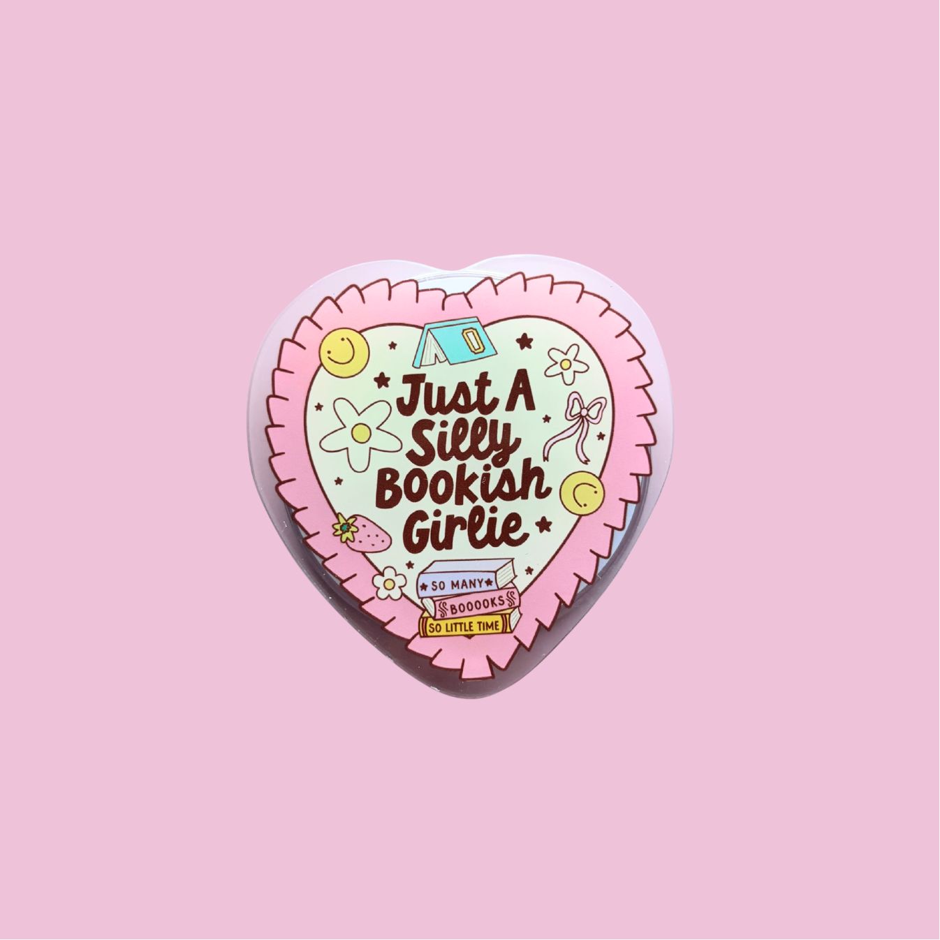 A heart-shaped sticker with a pink background and various colorful illustrations, including flowers, stars, and a smiling face.