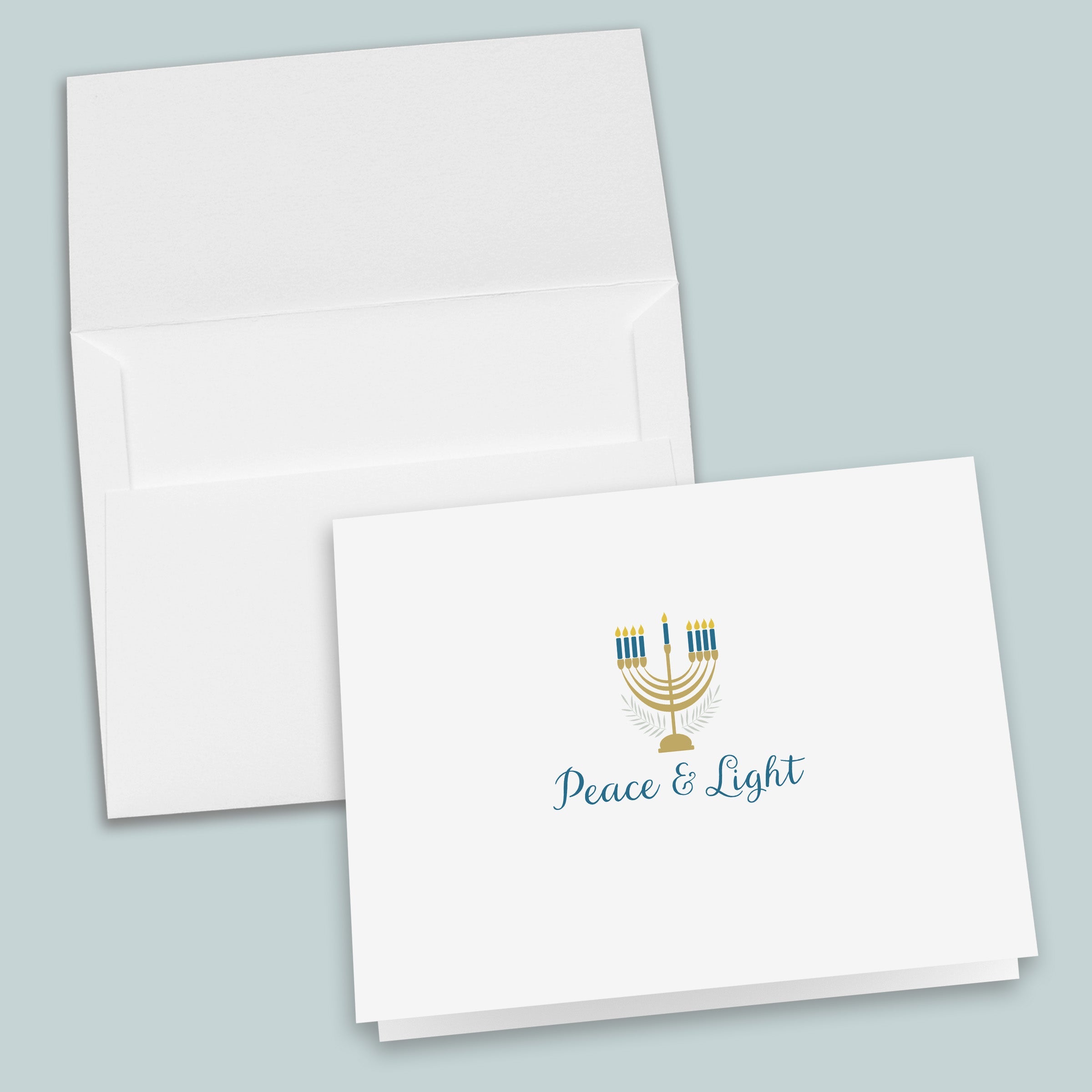 a white envelope with a printed design and text on it, and the text on the envelope reads "Peace & Light".