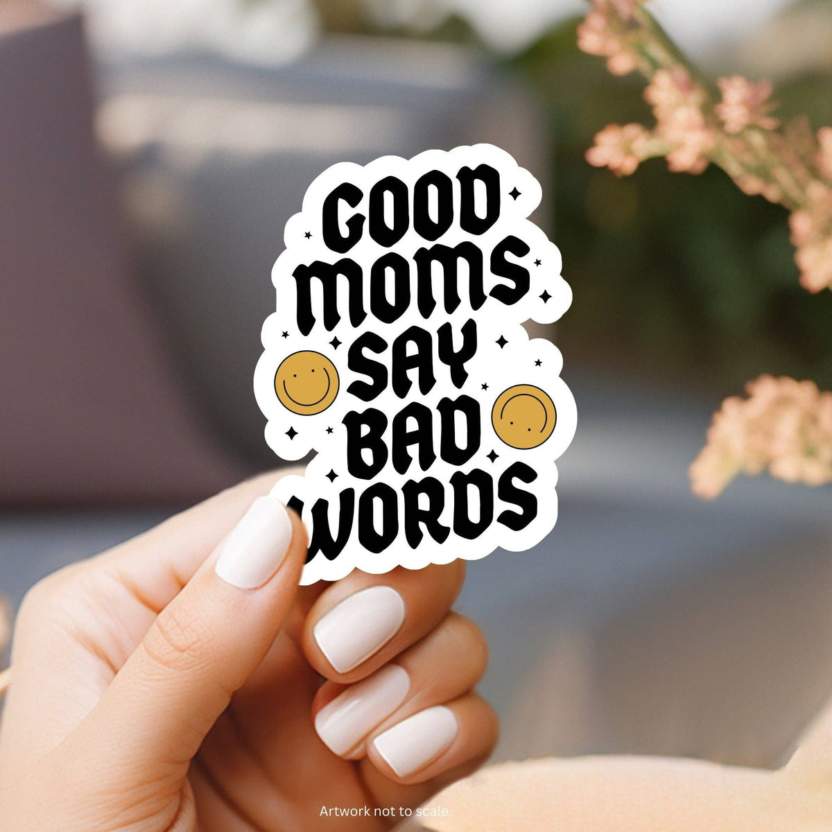 Hand holding a sticker with &