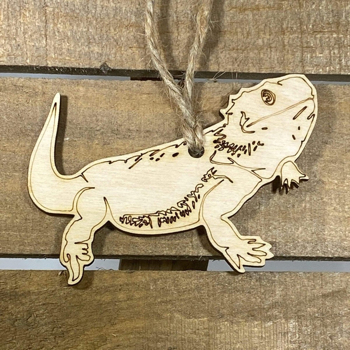 Hand-painted wooden bearded dragon Christmas ornament featuring a detailed reptile design with textured scales and spiky beard, unique holiday decor for reptile lovers and exotic pet enthusiasts by Cate’s Concepts