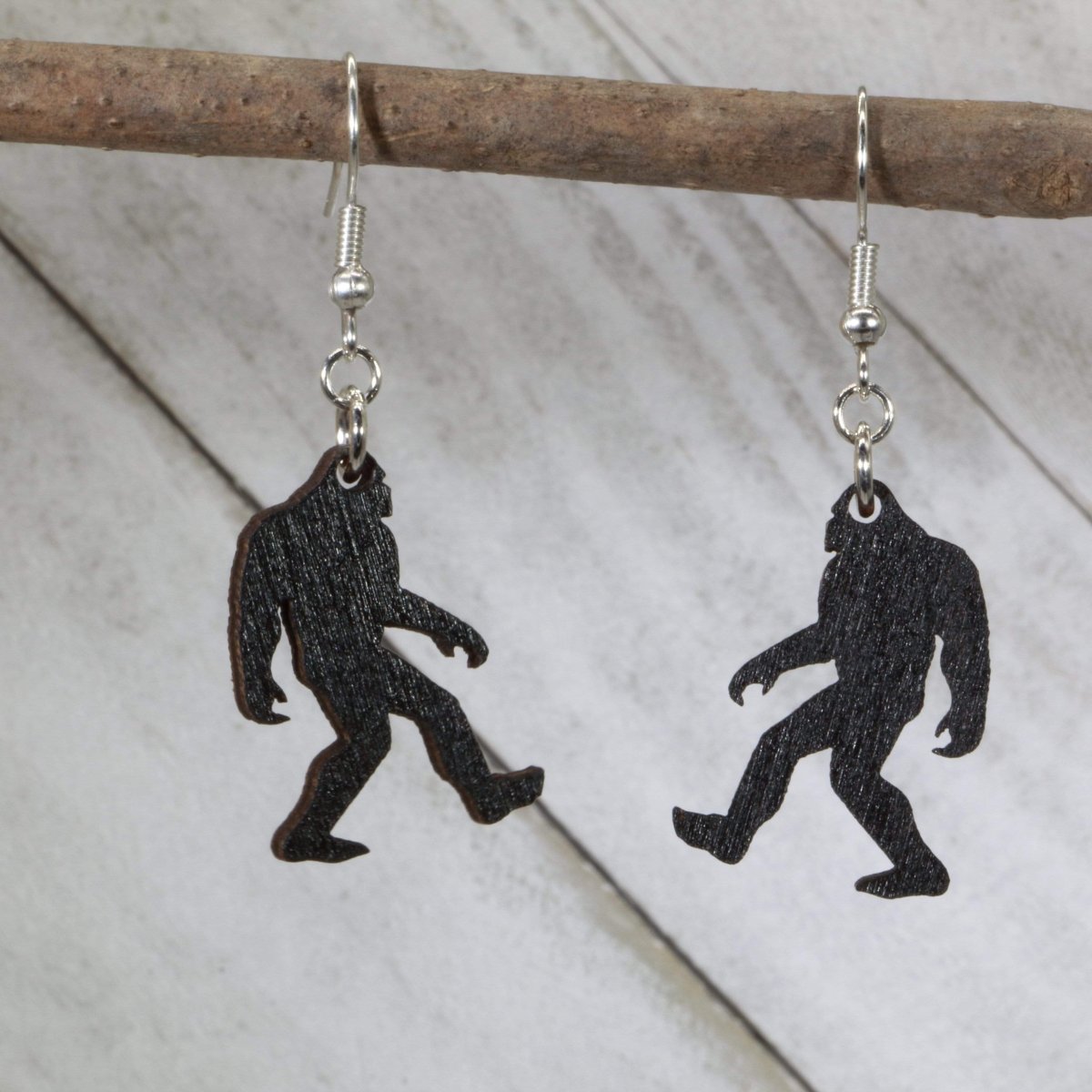 Hand-painted wooden Bigfoot dangle earrings with Sasquatch cryptid design and hypoallergenic sterling silver hooks, quirky cryptozoology statement jewelry earrings for Bigfoot lovers