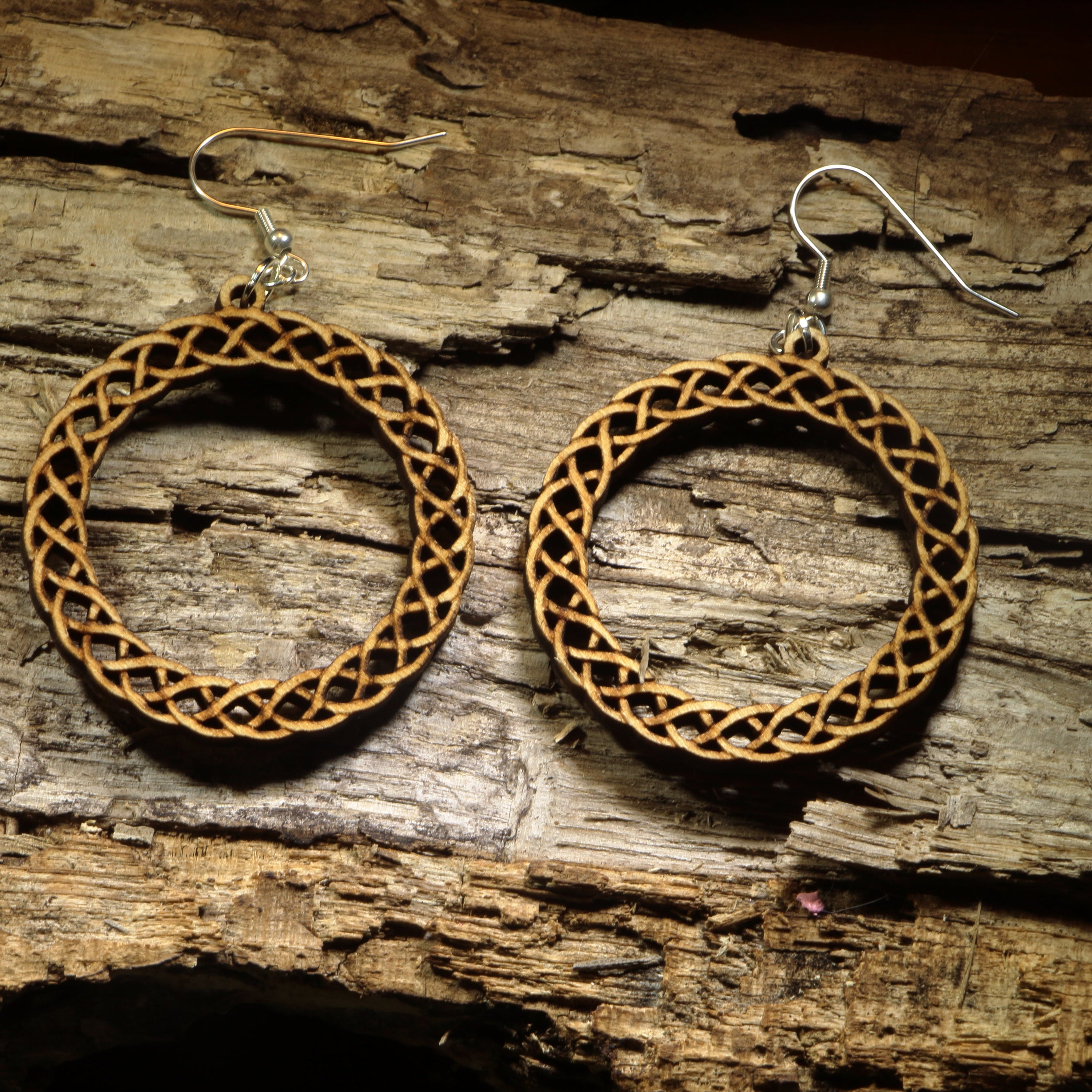 Hand-painted wooden Celtic knot hoop dangle earrings featuring an intricate interwoven Celtic knot design symbolizing eternity, unity, and heritage. Crafted from lightweight wood with hypoallergenic .925 sterling silver hooks, these artisan earrings are perfect for Celtic heritage, Irish and Scottish pride, Renaissance fairs, St. Patrick&