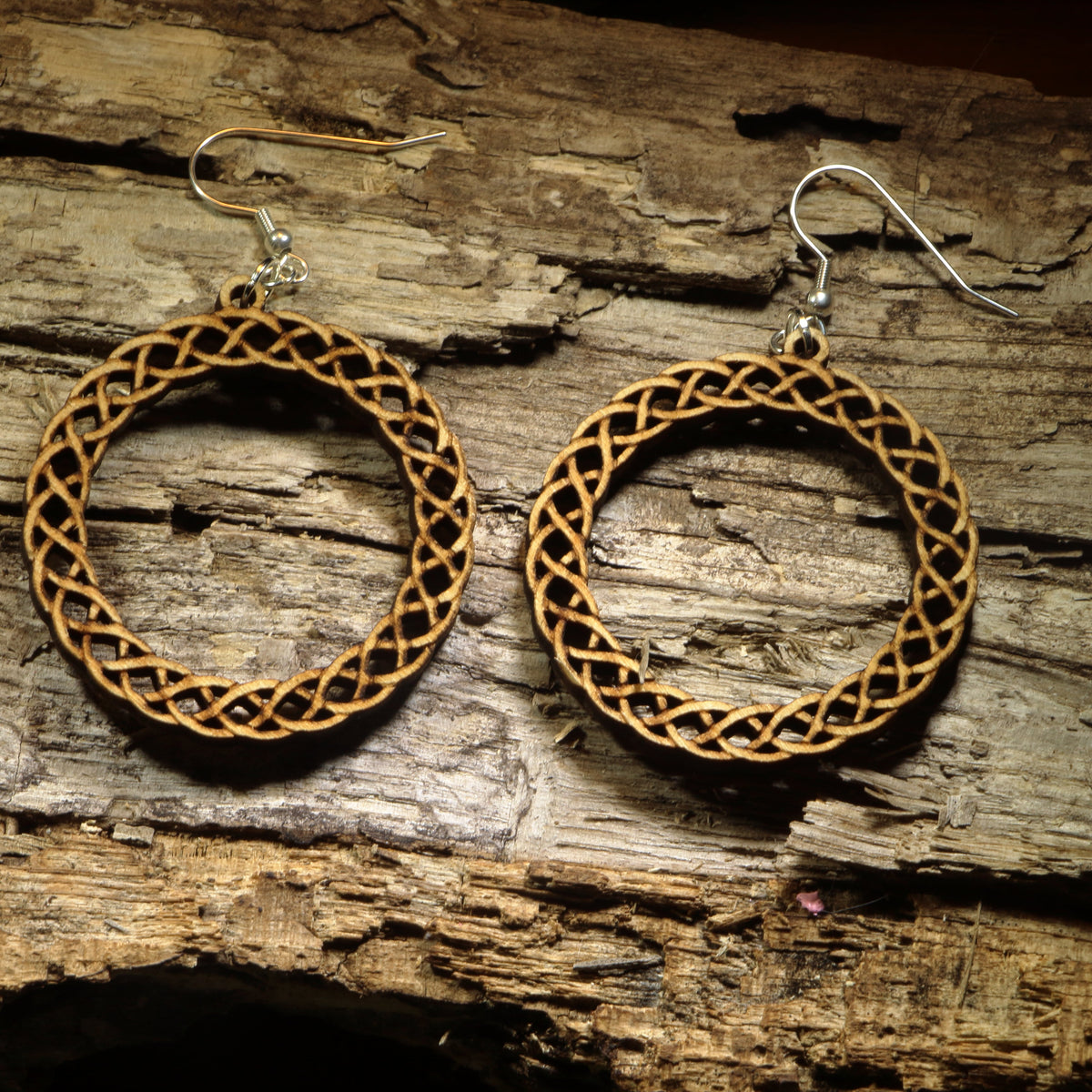 Hand-painted wooden Celtic knot hoop dangle earrings featuring an intricate interwoven Celtic knot design symbolizing eternity, unity, and heritage. Crafted from lightweight wood with hypoallergenic .925 sterling silver hooks, these artisan earrings are perfect for Celtic heritage, Irish and Scottish pride, Renaissance fairs, St. Patrick&
