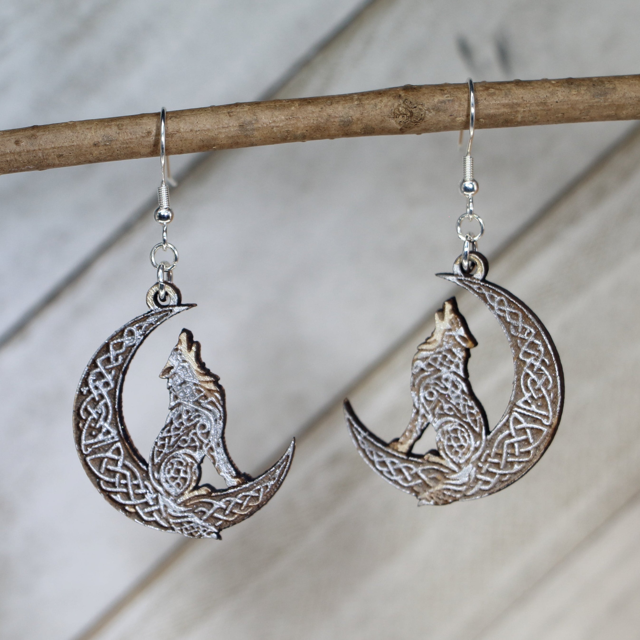Hand-painted wooden Celtic wolf moon dangle earrings with Norse mythology design and hypoallergenic sterling silver hooks, lightweight mystical jewelry for wolf lovers and pagan-inspired style by Cate’s Concepts