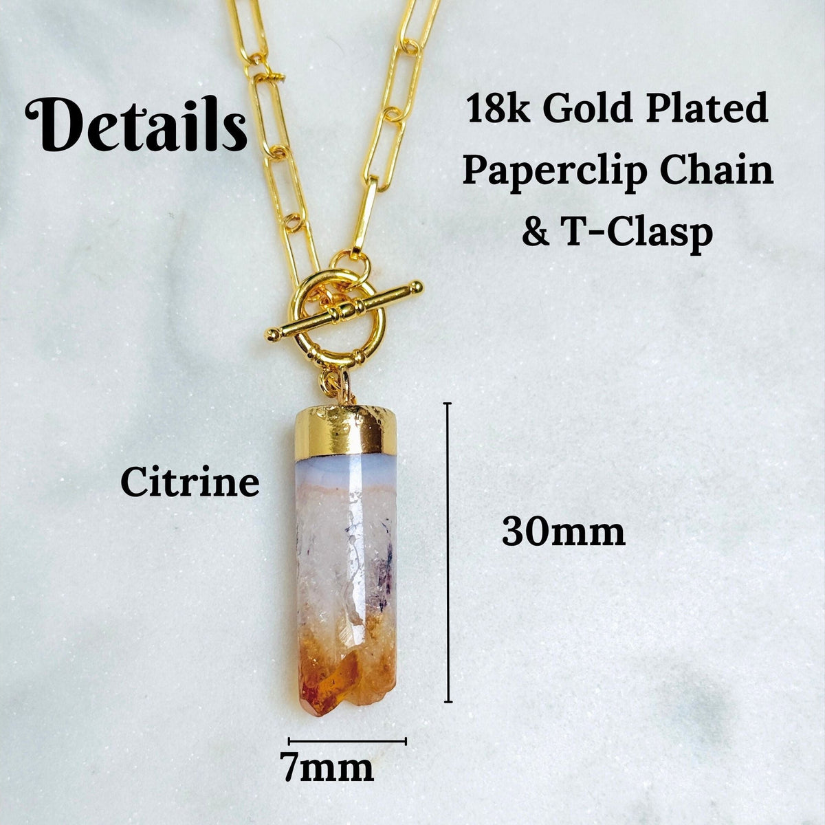 Citrine crystal pendant necklace with a 18k gold-plated paperclip chain and toggle clasp, shown with dimension labels indicating 30mm length and 7mm width on a light marble background.