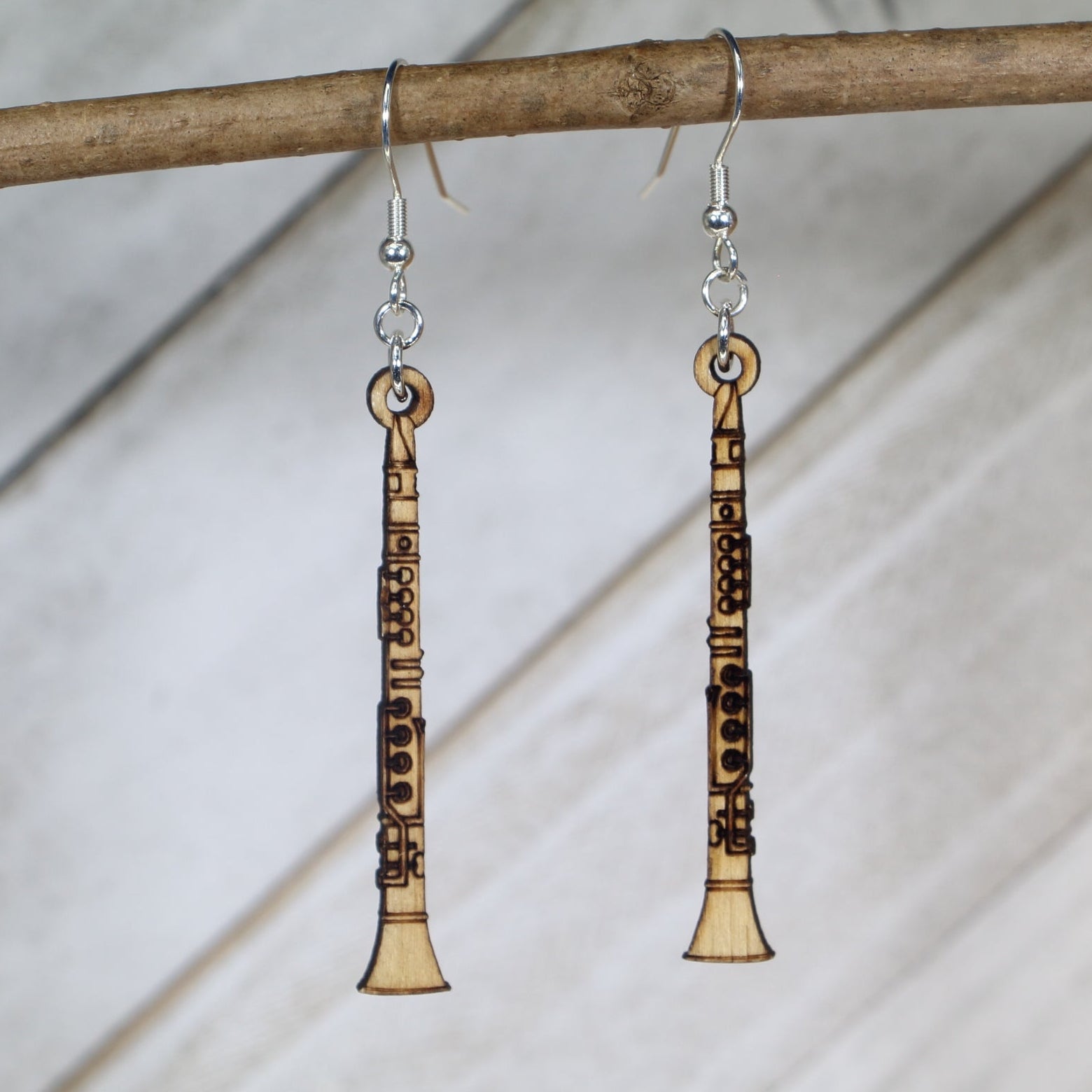 Hand-painted wooden clarinet dangle earrings featuring a detailed straight instrument design with keywork and mouthpiece accents and hypoallergenic sterling silver hooks, lightweight jewelry for band members and woodwind enthusiasts by Cate’s Concepts