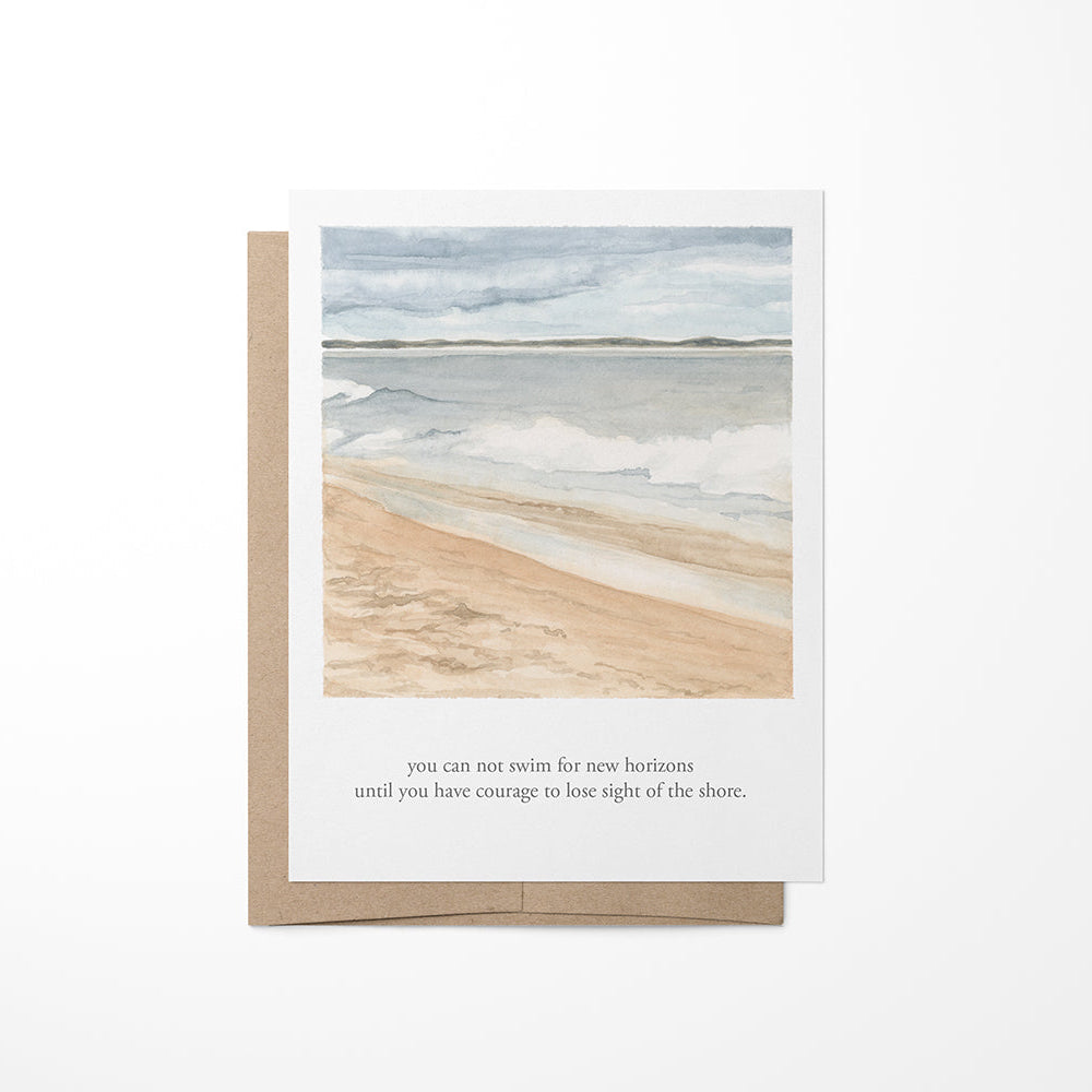 A greeting card with a watercolor painting of a coastal beach and a quote