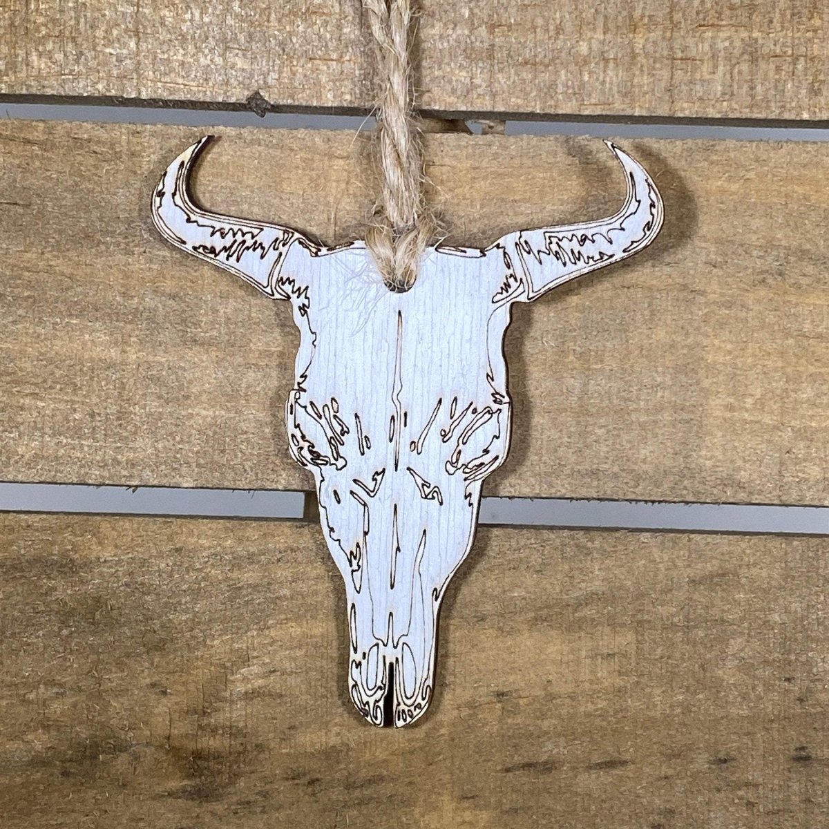 Hand-painted wooden cow skull Christmas ornament featuring a rustic Western design with long horns and detailed bone accents, unique holiday decor for ranch lovers and Southwestern style enthusiasts by Cate’s Concepts