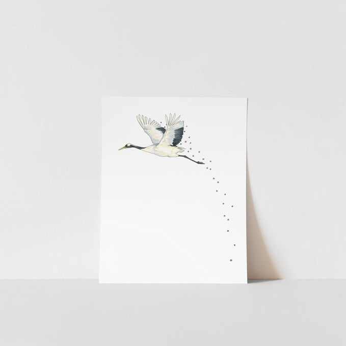 A art print of a Japanese crane with a blossom in its beak, printed on ultra premium matte paper with archival inks, signed by Heather S Vitticore.