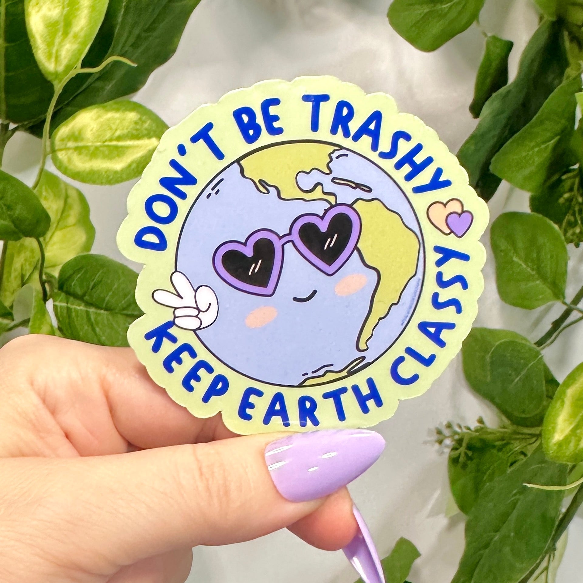Sticker with Earth design with purple heart sunglasses and peace fingers with wrapped circular text &