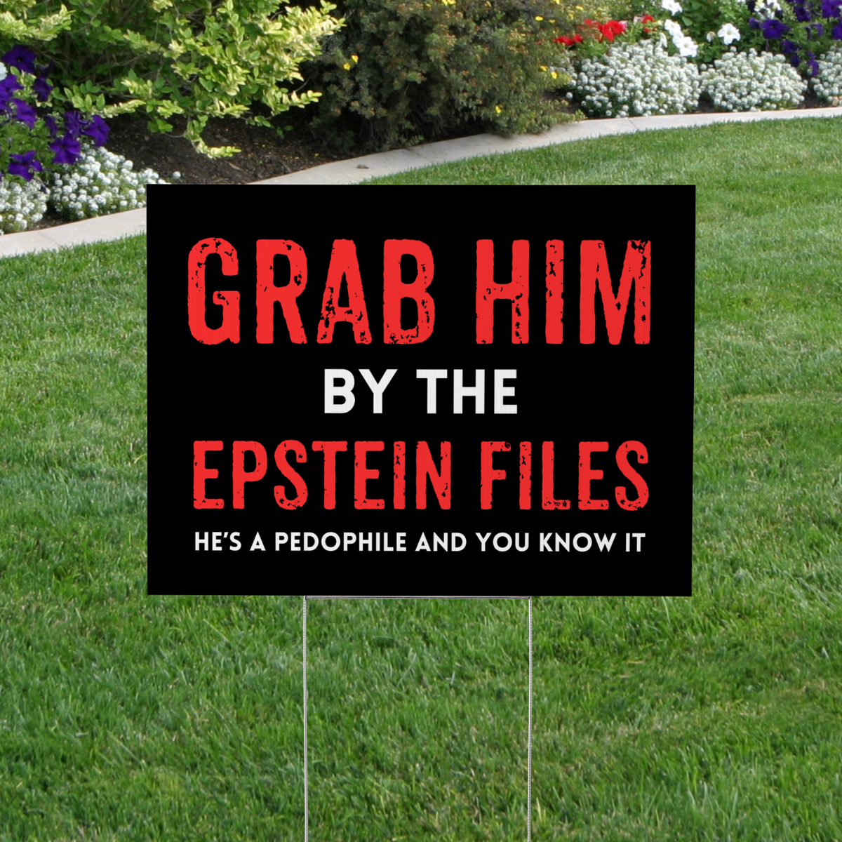 Political protest sign on grass with text &