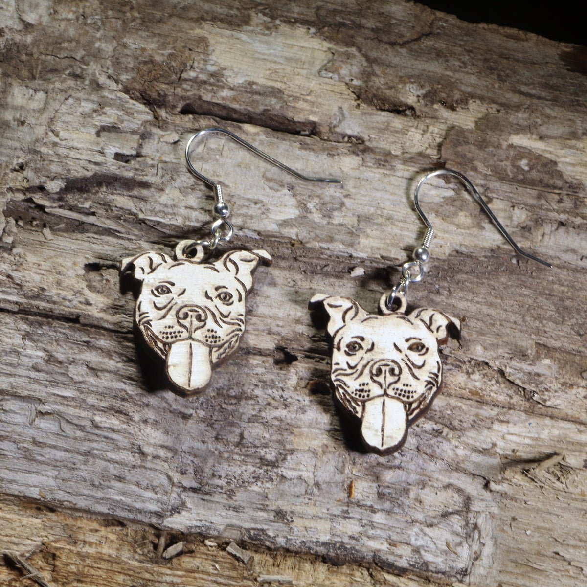 Hand-painted Pit Bull dog face wooden dangle earrings on hypoallergenic .925 sterling silver hooks. Lightweight Pit Bull jewelry featuring a happy Pit Bull with its tongue out, perfect for Pit Bull owners, rescue advocates, dog lovers, and bully breed enthusiasts.
