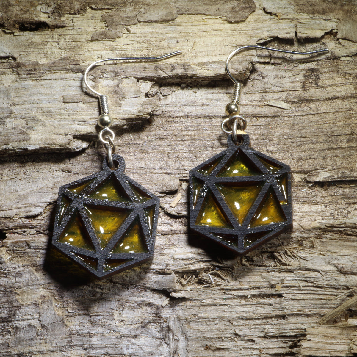 Hand-painted Resin D20 Dice wooden dangle earrings featuring the iconic 20-sided die with colorful resin accents. Lightweight and fun, they’re perfect for tabletop gamers, RPG players, dungeon masters, dice collectors, and game night adventures.