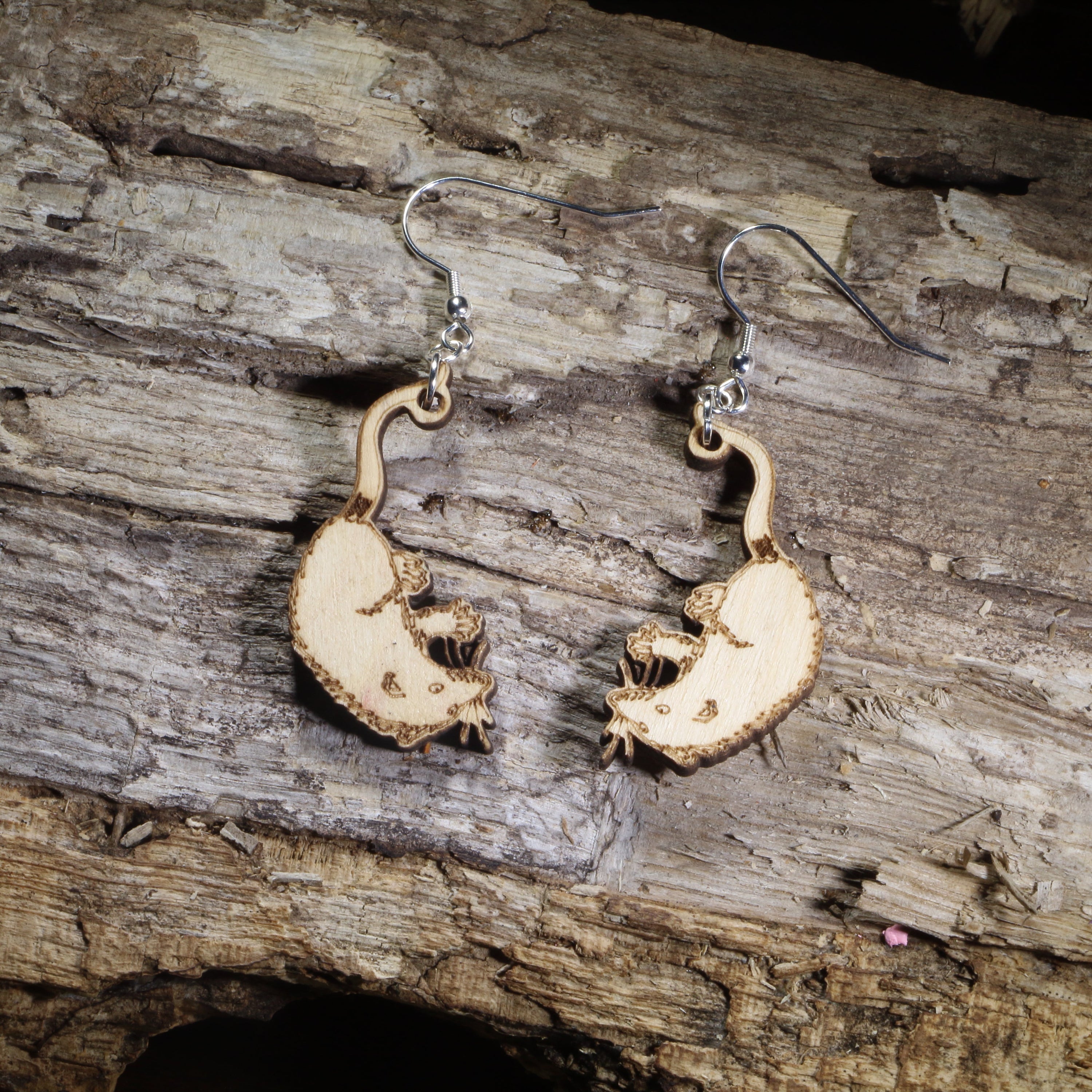 Hand-painted wooden Virginia opossum dangle earrings featuring detailed opossum silhouettes on hypoallergenic .925 sterling silver hooks. Lightweight woodland animal jewelry for opossum lovers, wildlife enthusiasts, nature lovers, and unique animal accessory collectors.