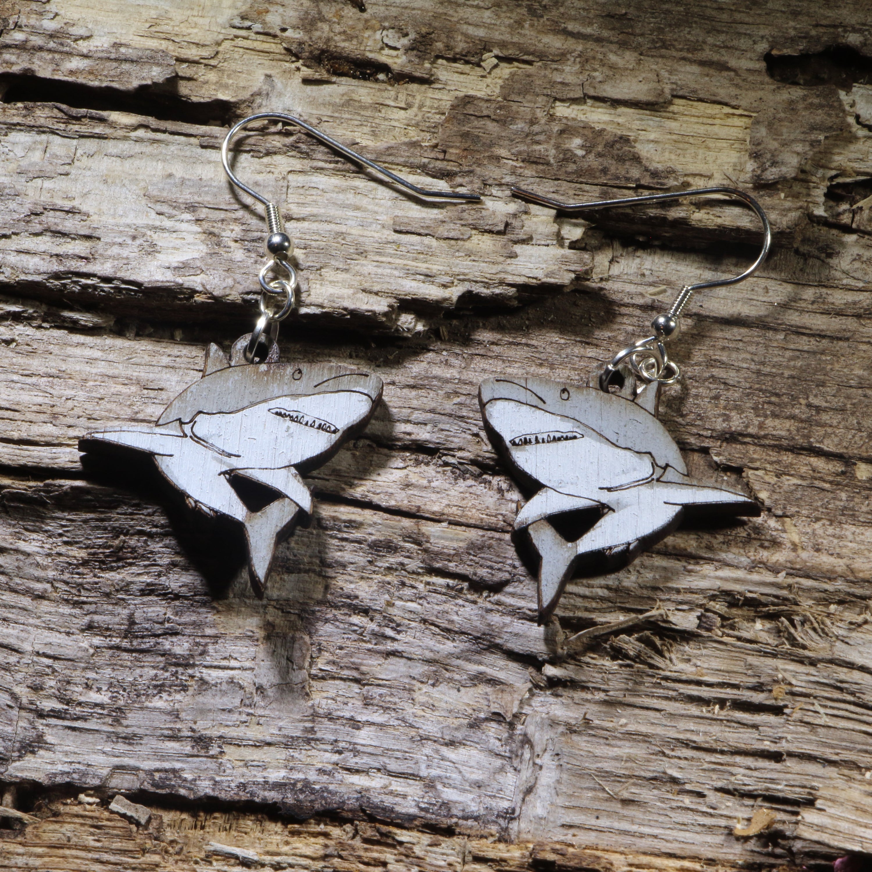Hand-painted wooden great white shark dangle earrings featuring a detailed great white shark silhouette with engraved gill and fin accents. Lightweight ocean-inspired earrings with hypoallergenic .925 sterling silver hooks, perfect for shark lovers, marine biology enthusiasts, scuba divers, ocean conservation supporters, beach lovers, and anyone who loves unique handmade sea life jewelry.