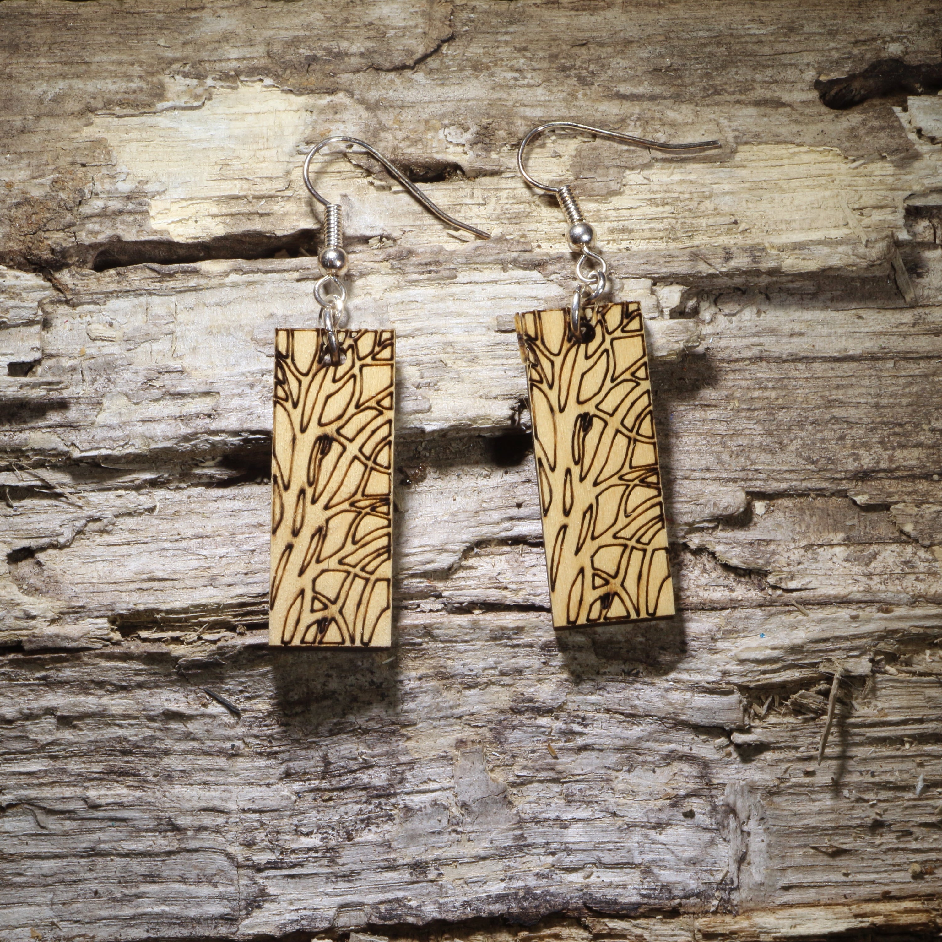 Handcrafted wooden bar dangle earrings featuring an engraved tree bark and wood grain pattern on natural wood. Lightweight nature-inspired earrings with hypoallergenic .925 sterling silver hooks, perfect for forest lovers, rustic style, outdoor enthusiasts, and minimalist handmade jewelry.