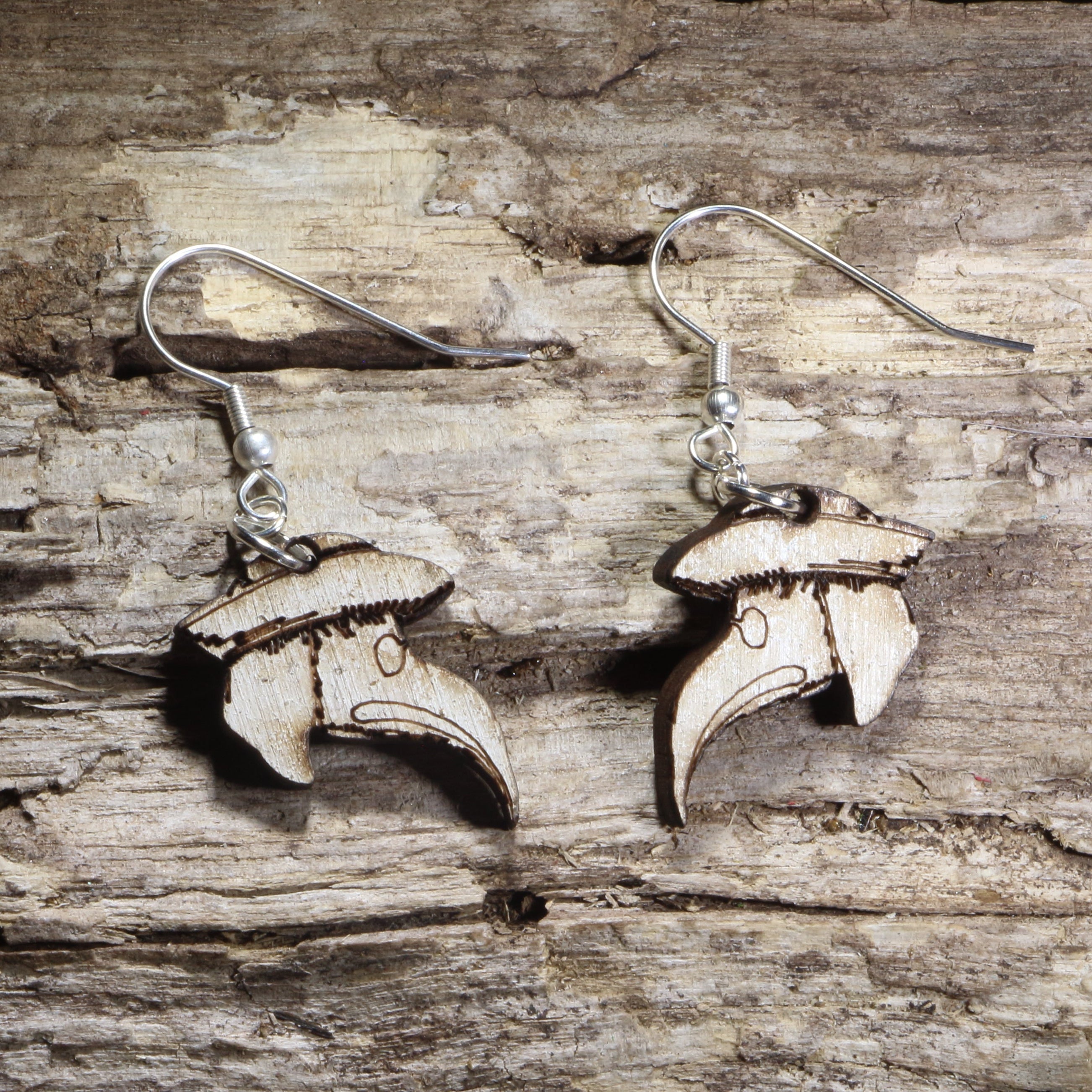 Handmade wooden plague doctor mask dangle earrings featuring the iconic beaked plague doctor mask with a wide-brimmed hat on hypoallergenic .925 sterling silver hooks. Lightweight gothic-inspired jewelry for horror fans, dark academia, Halloween, historical costume enthusiasts, and lovers of spooky accessories.