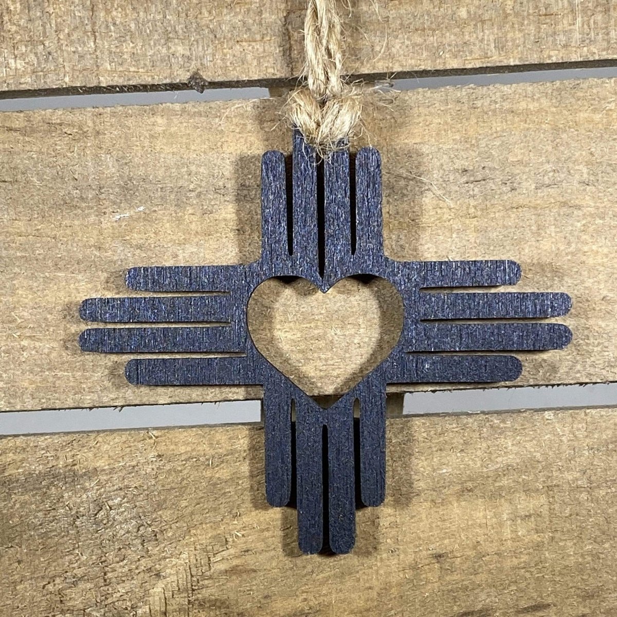 Hand-painted wooden heart Zia Christmas ornament featuring a bold Southwest sun symbol within a heart design, unique holiday decor for New Mexico lovers and Southwestern style enthusiasts by Cate’s Concepts