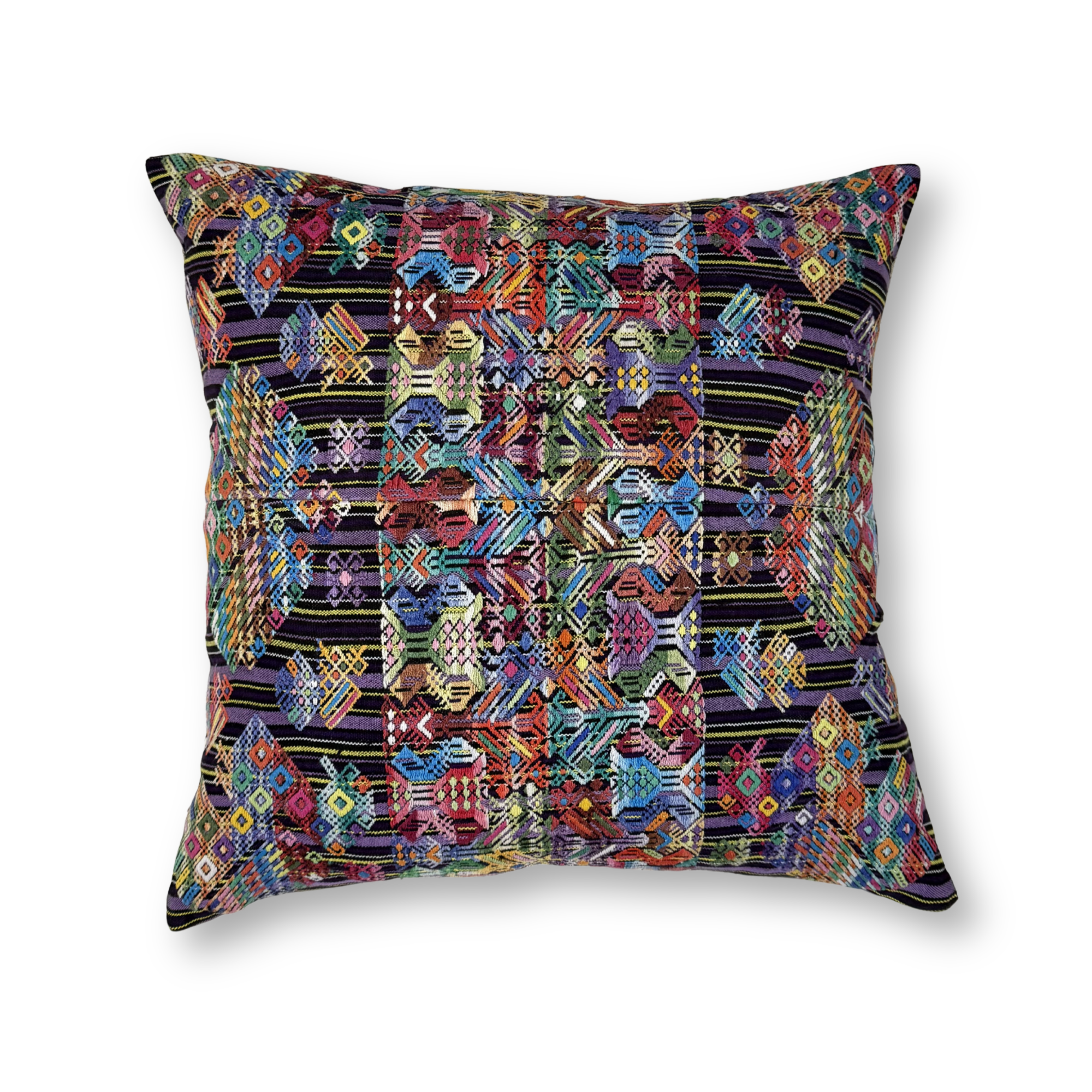 Multicolored geometric patterned pillow on a white background