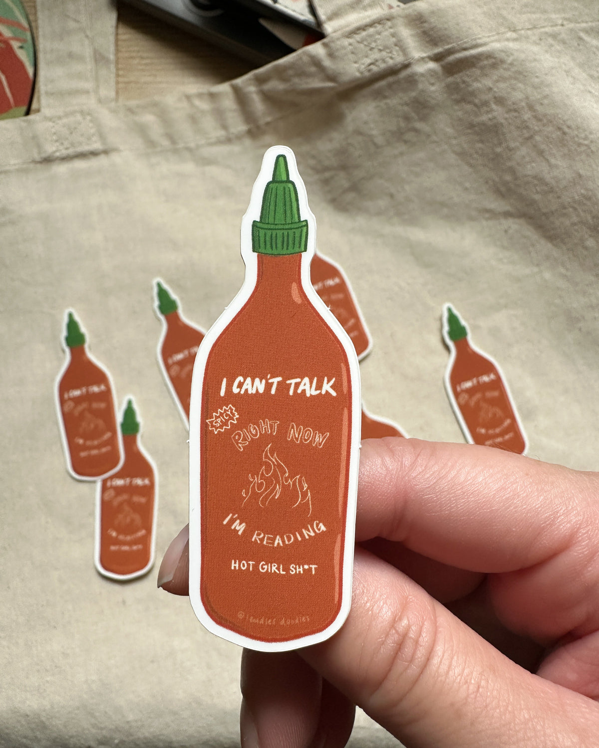 a 3 inch sticker of hot sauce with text saying "I can&