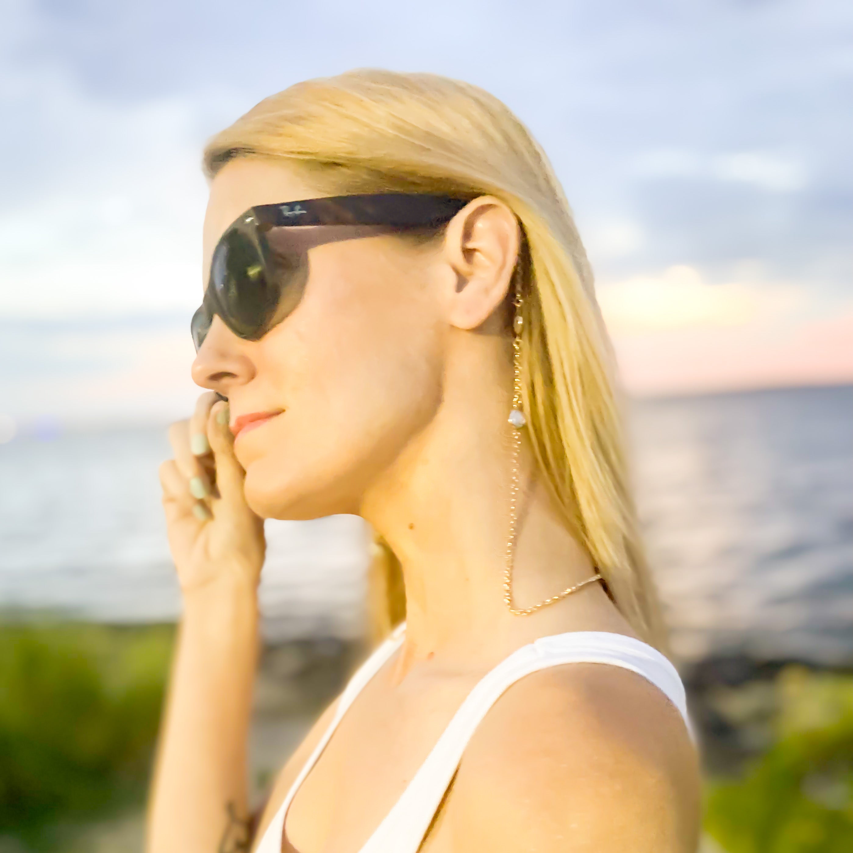 model wearing sunglasses with naples coin pearl sunglass / mask chain