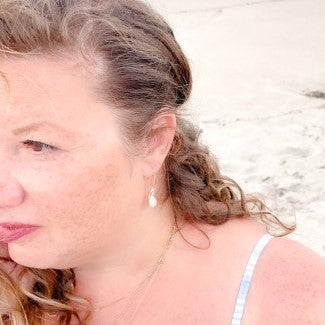 ocean springs organic pear shape pearl earrings on founder of the beach and back