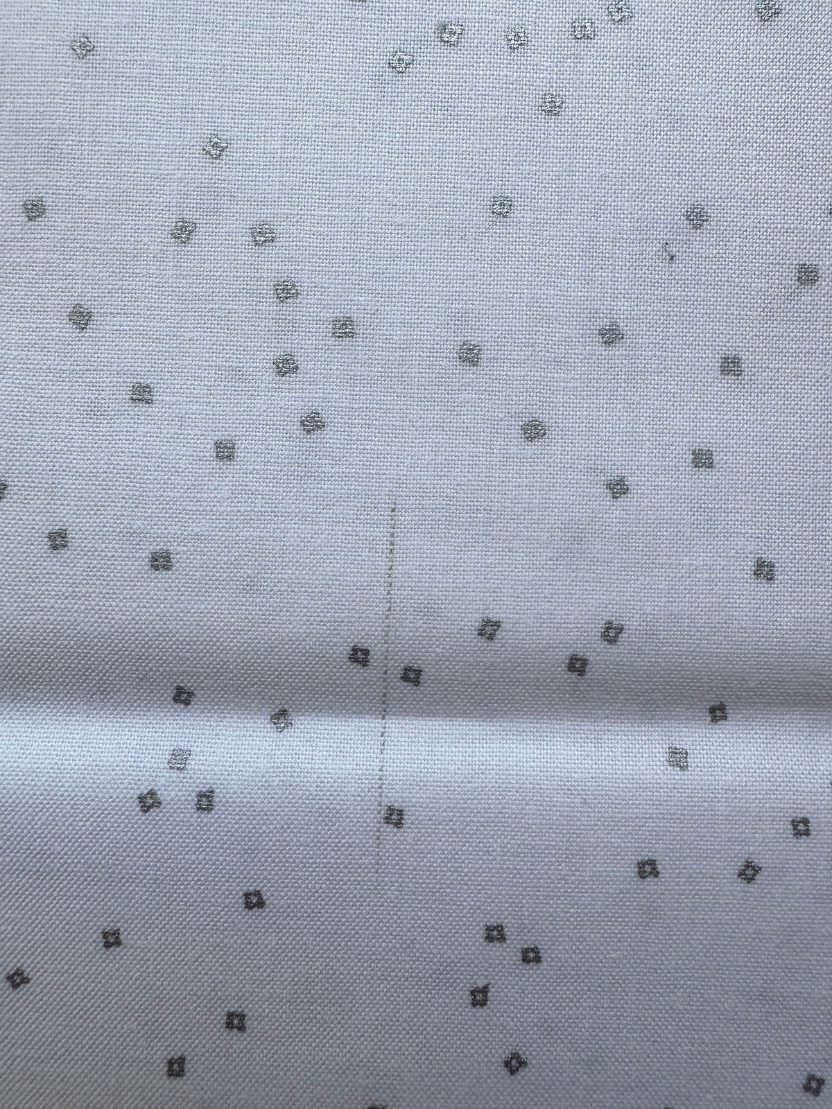 White fabric with small silver diamond patterns
