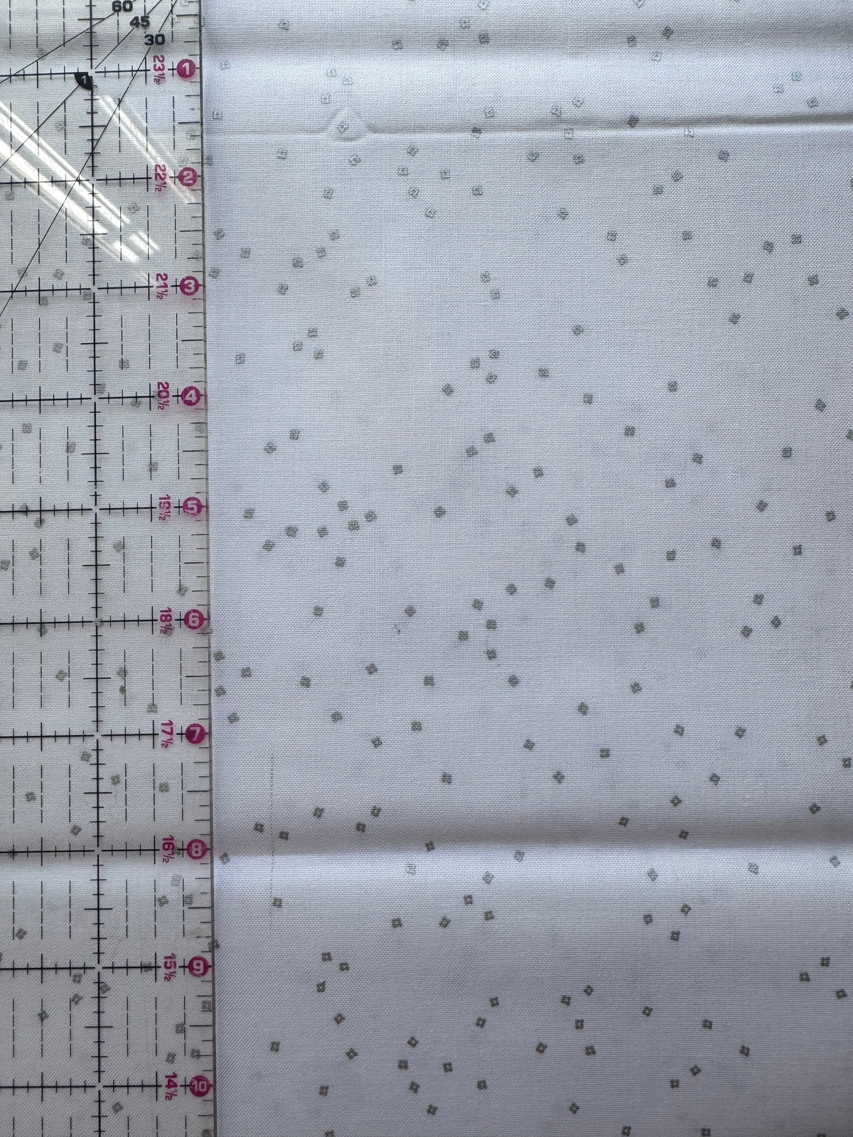 White fabric with small silver diamond patterns