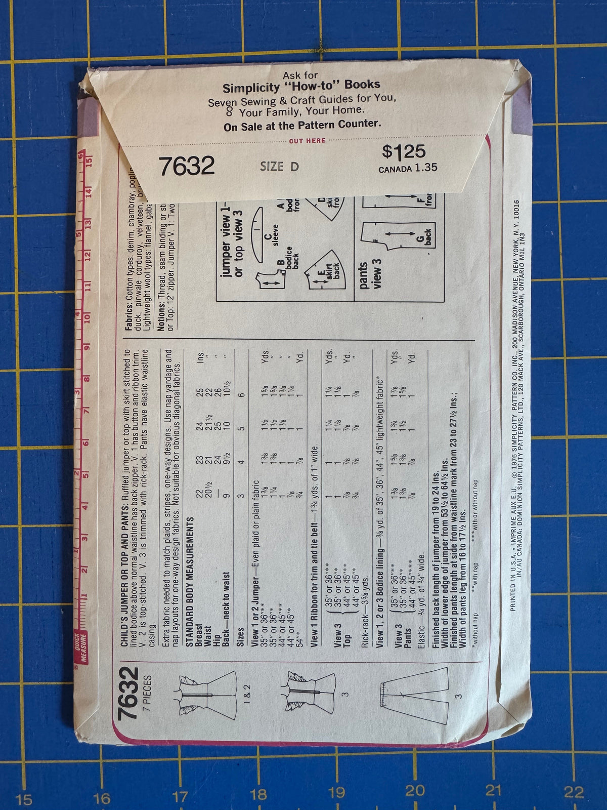A vintage Simplicity sewing pattern envelope, size D, number 7632, for a corset, laid flat on a blue cutting mat with grid lines.