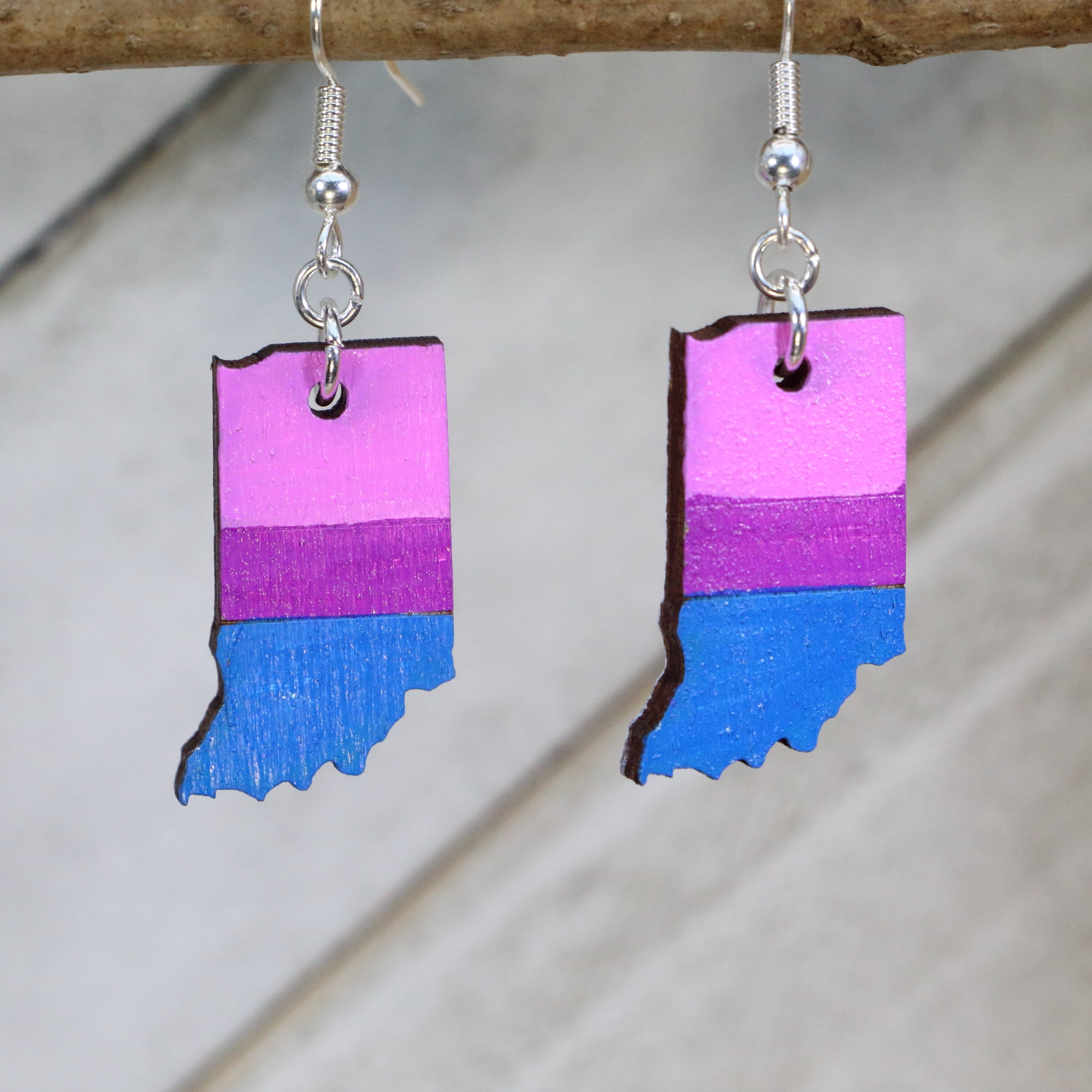 Hand-painted wooden Indiana bisexual pride flag dangle earrings with bisexual pride colors and Indiana state design, hypoallergenic sterling silver hooks, and lightweight LGBTQ jewelry for state pride and inclusive style by Cate’s Concepts
