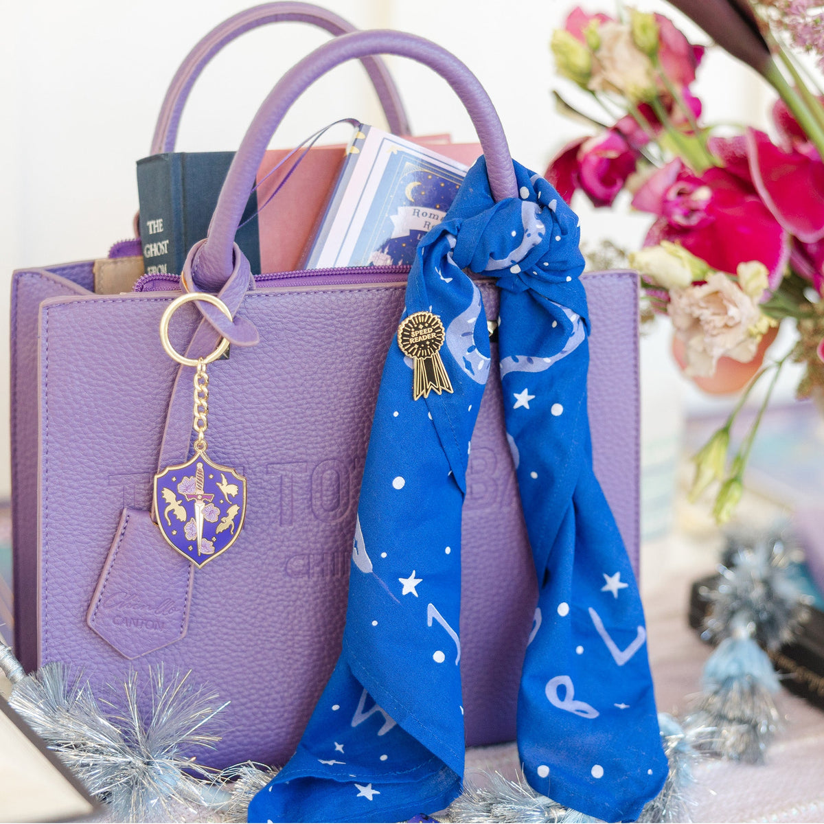 Romantasy Shield keychain in use on bag showing medieval shield design detail and gold finish, Jollity & Co.